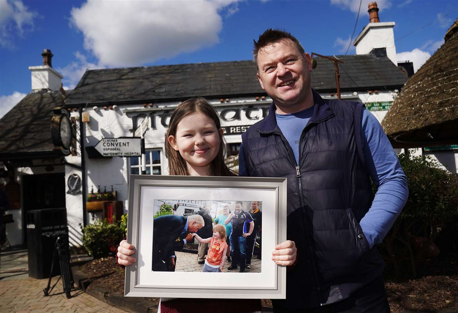 Aoibhinn Brennan, 12, from Lordship, Co Louth, with her father Shane Brennan outside Fitzpatrick’s Pub & Restaurant in Jenkinstown, where as a five-year-old she met then vice president Joe Biden during his visit in 2016 (Brian Lawless/PA)