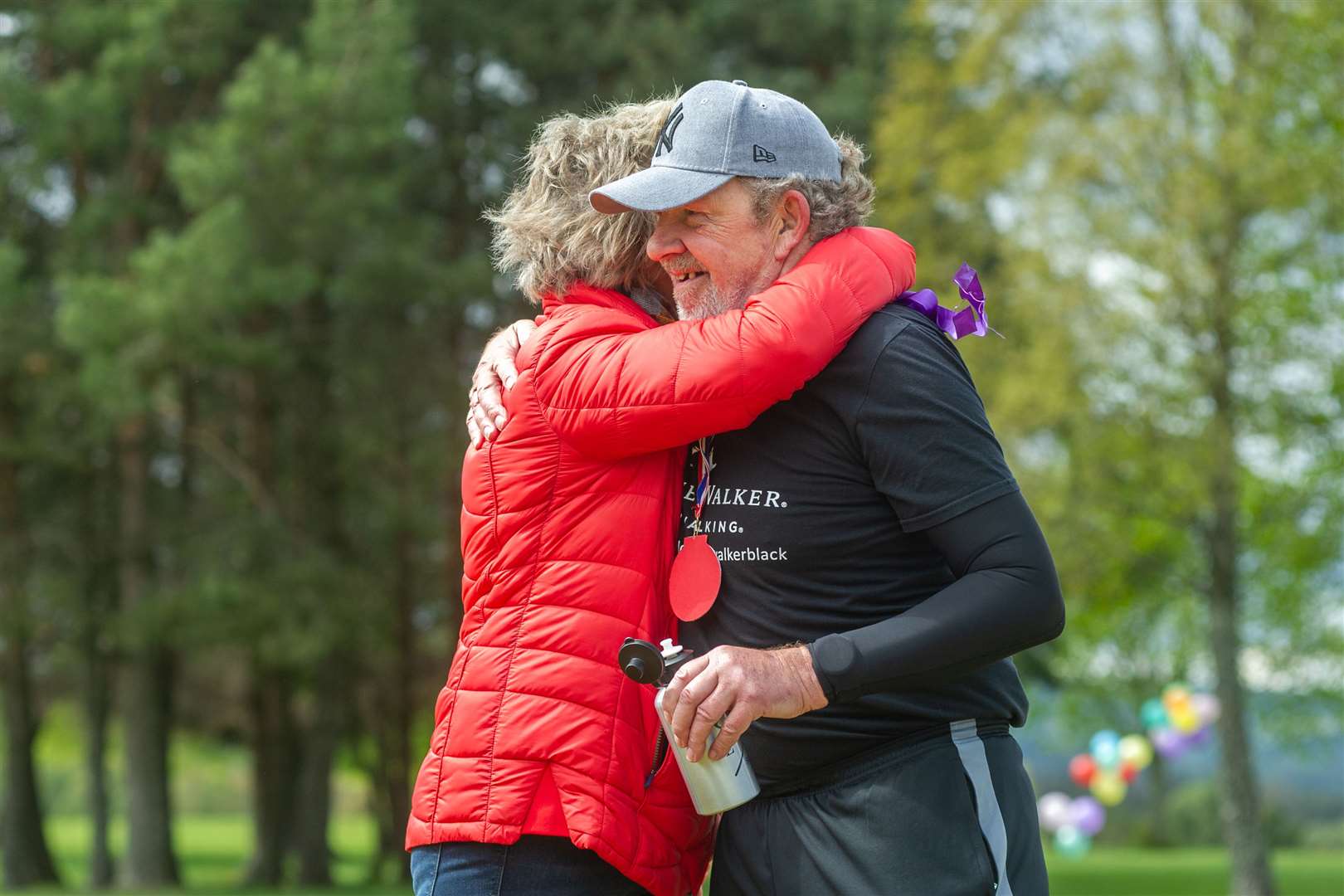 Eric is embraced by wife Sheila at the end of his marathon effort. Picture: Daniel Forsyth..