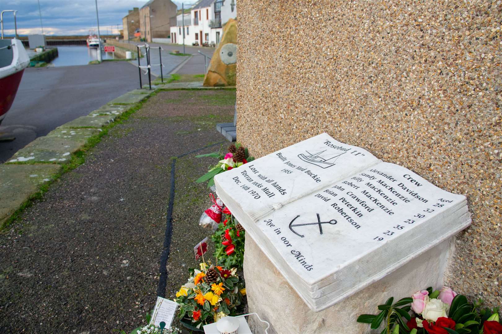 A marble open book has been placed at the harbour in Burghead in memory of the seven crewmen who died in the Rosebud II disaster 50 years ago. Picture: Daniel Forsyth.