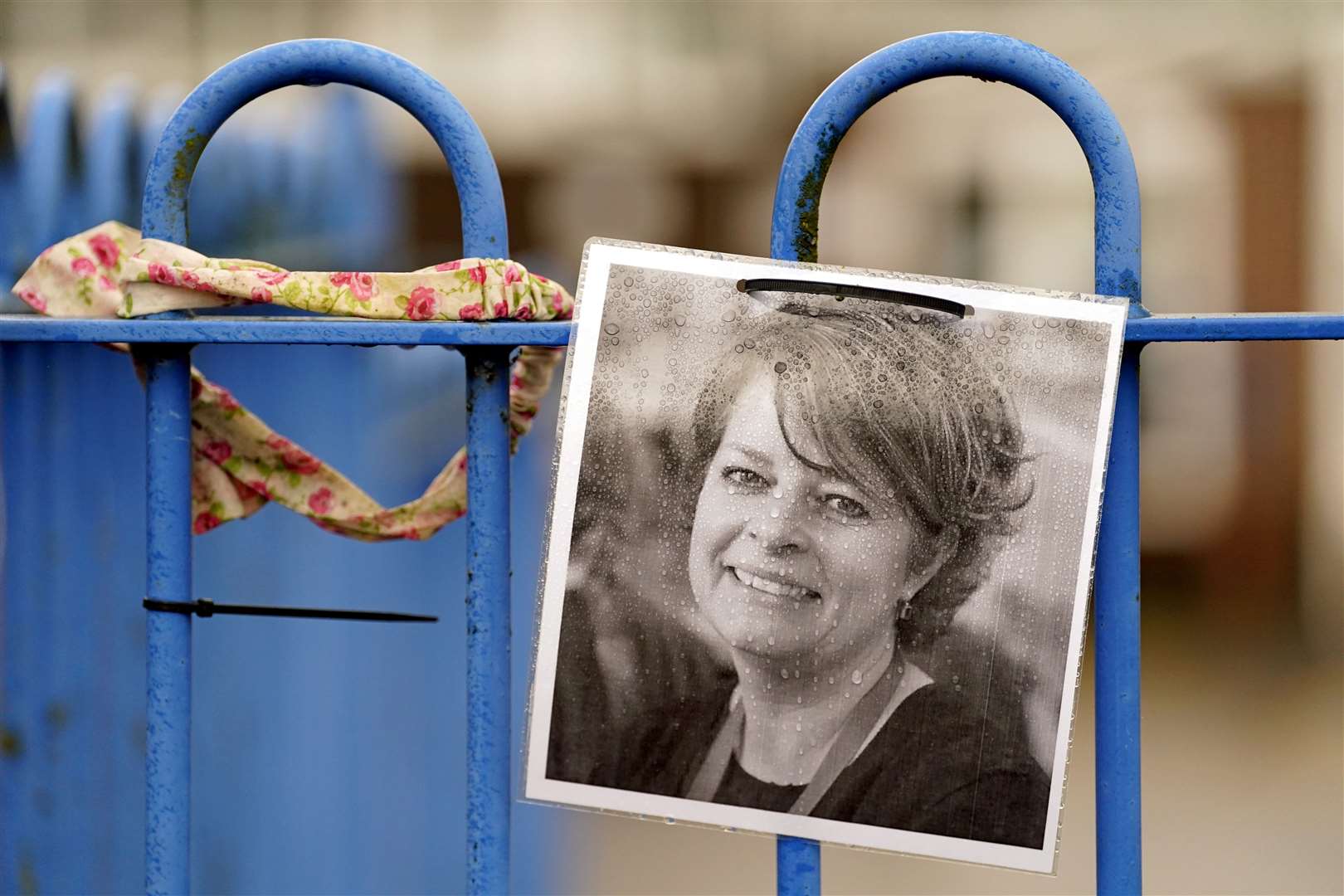 A photograph of Ruth Perry attached to the fence outside John Rankin Schools in Newbury (PA)