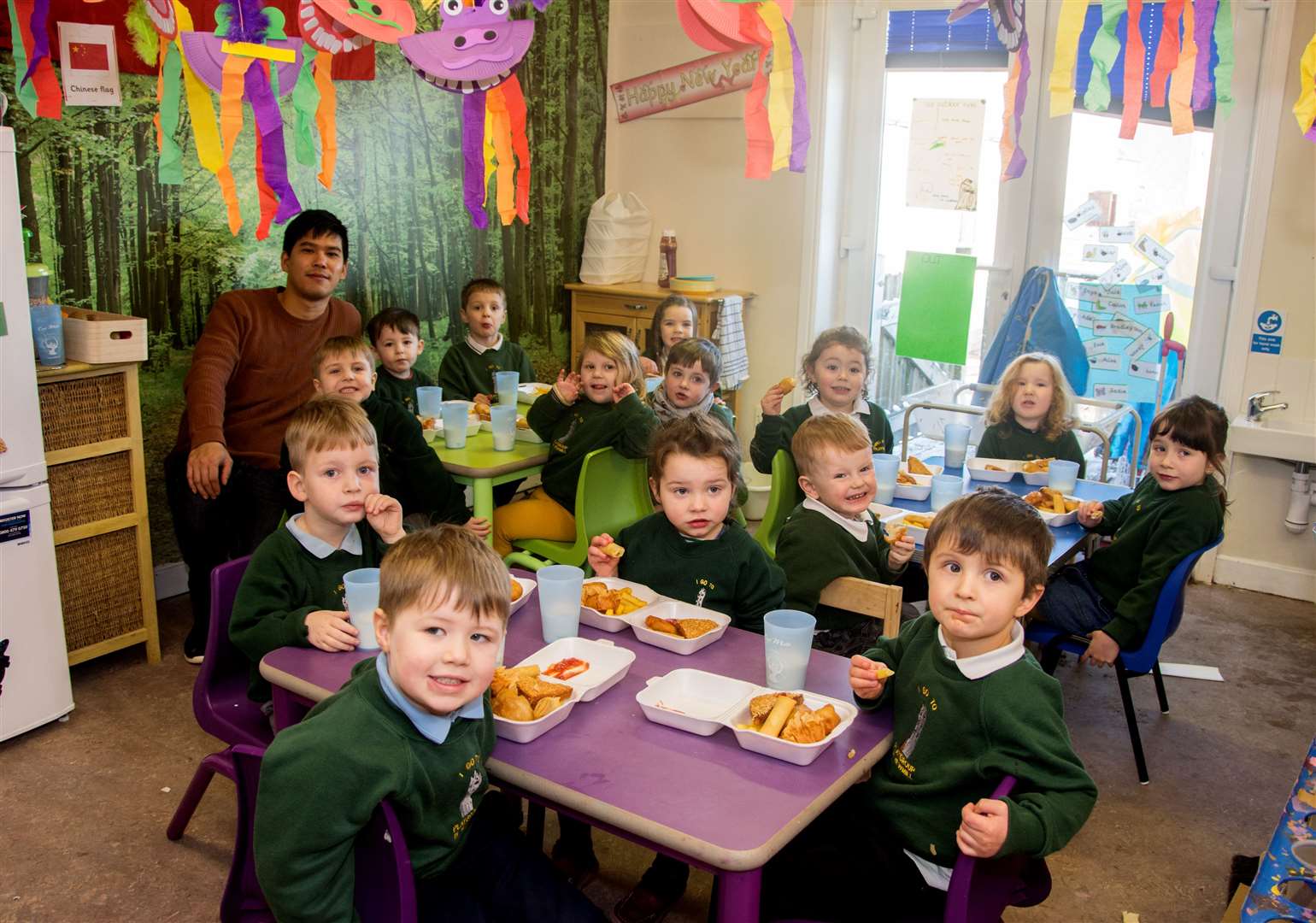 Alex Chen, of the Mayflower takeaway in Newmill, with Newmill Nursery children. Picture: Becky Saunderson.
