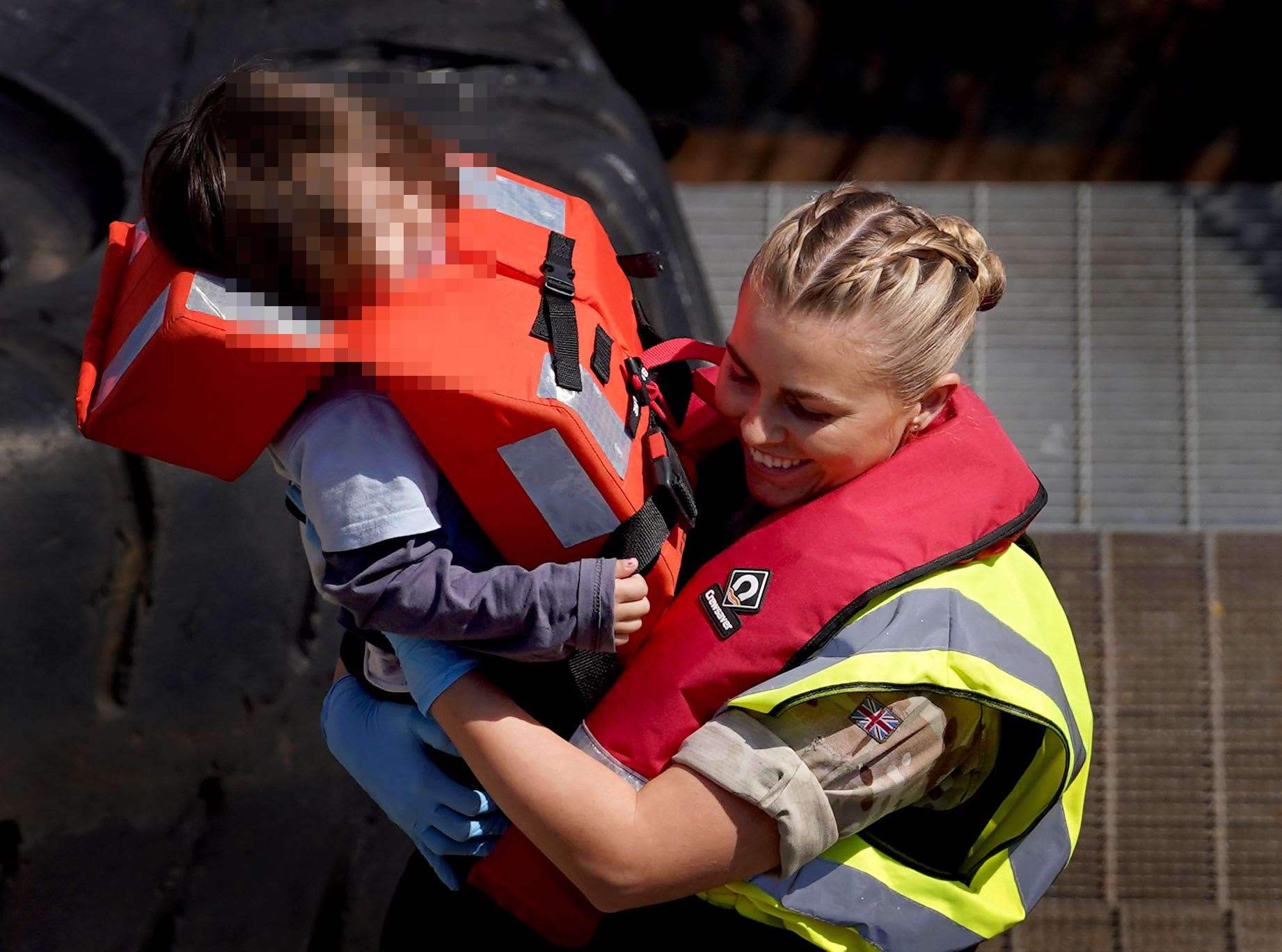 A young girl is carried by a member of the military in Dover, Kent, on Monday (Gareth Fuller/PA)