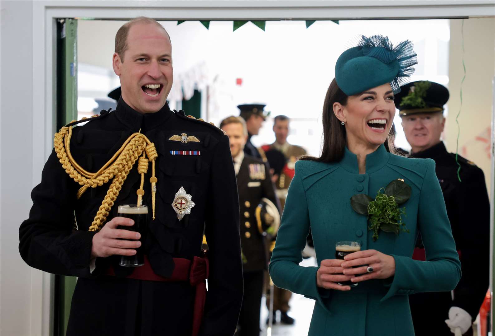 The Prince and Princess of Wales laugh and enjoy a glass of Guinness at Mons Barracks in Aldershot (Chris Jackson/PA)