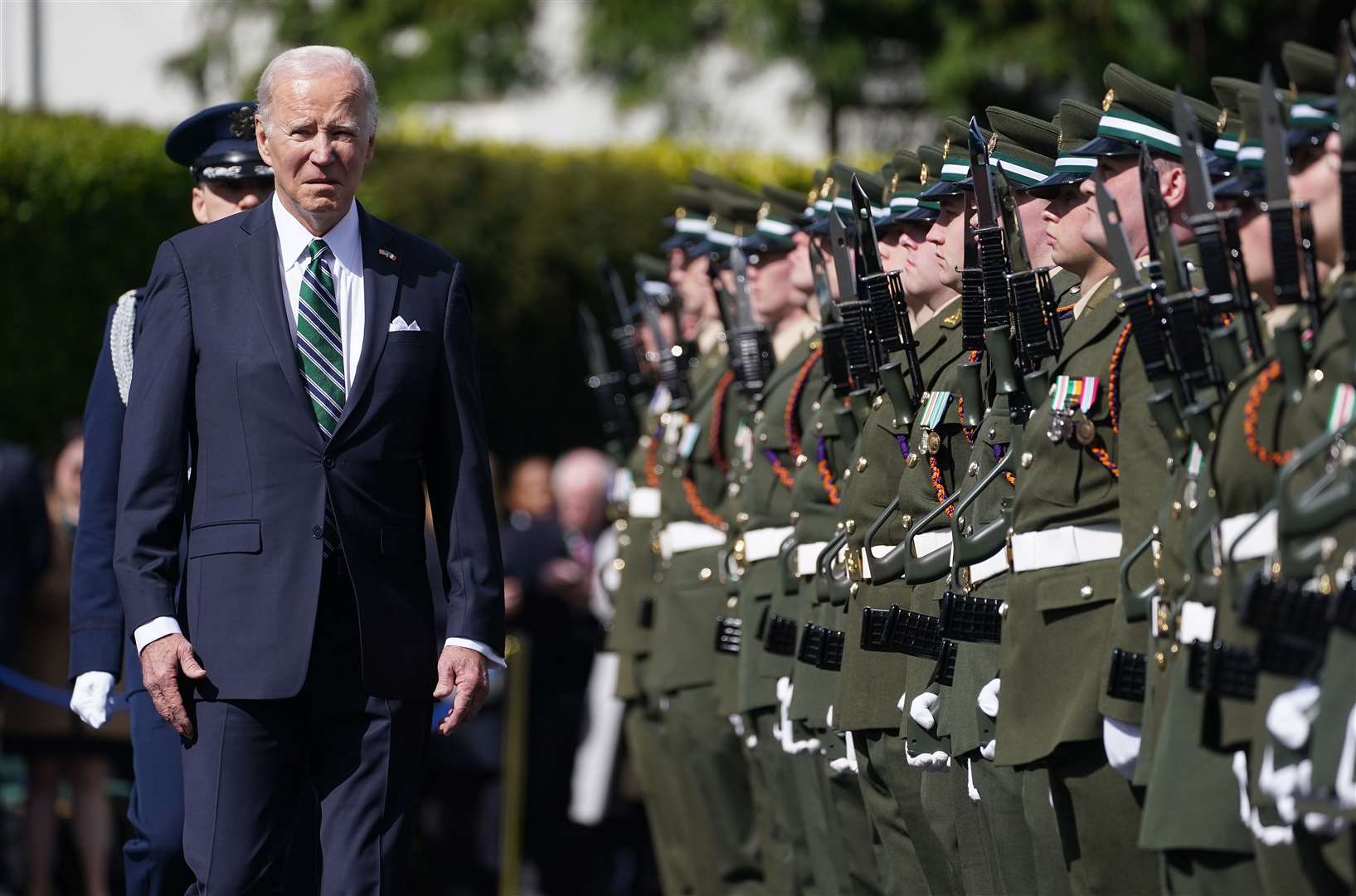 Joe Biden inspects the guard of honour during his visit to Aras an Uachtarain (Brian Lawless/PA)