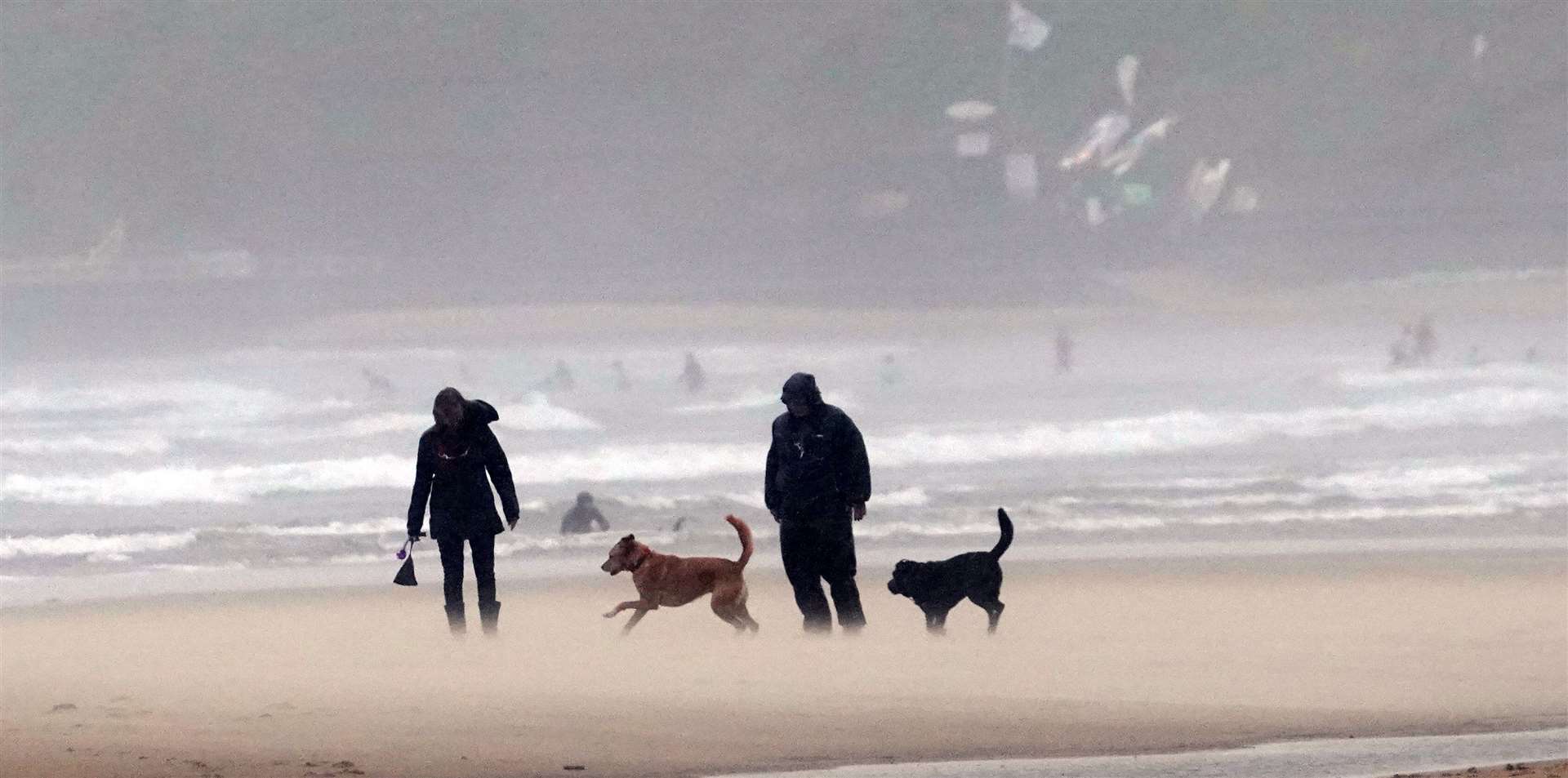 Walkers on a windy Tynemouth beach (Owen Humphreys/PA)