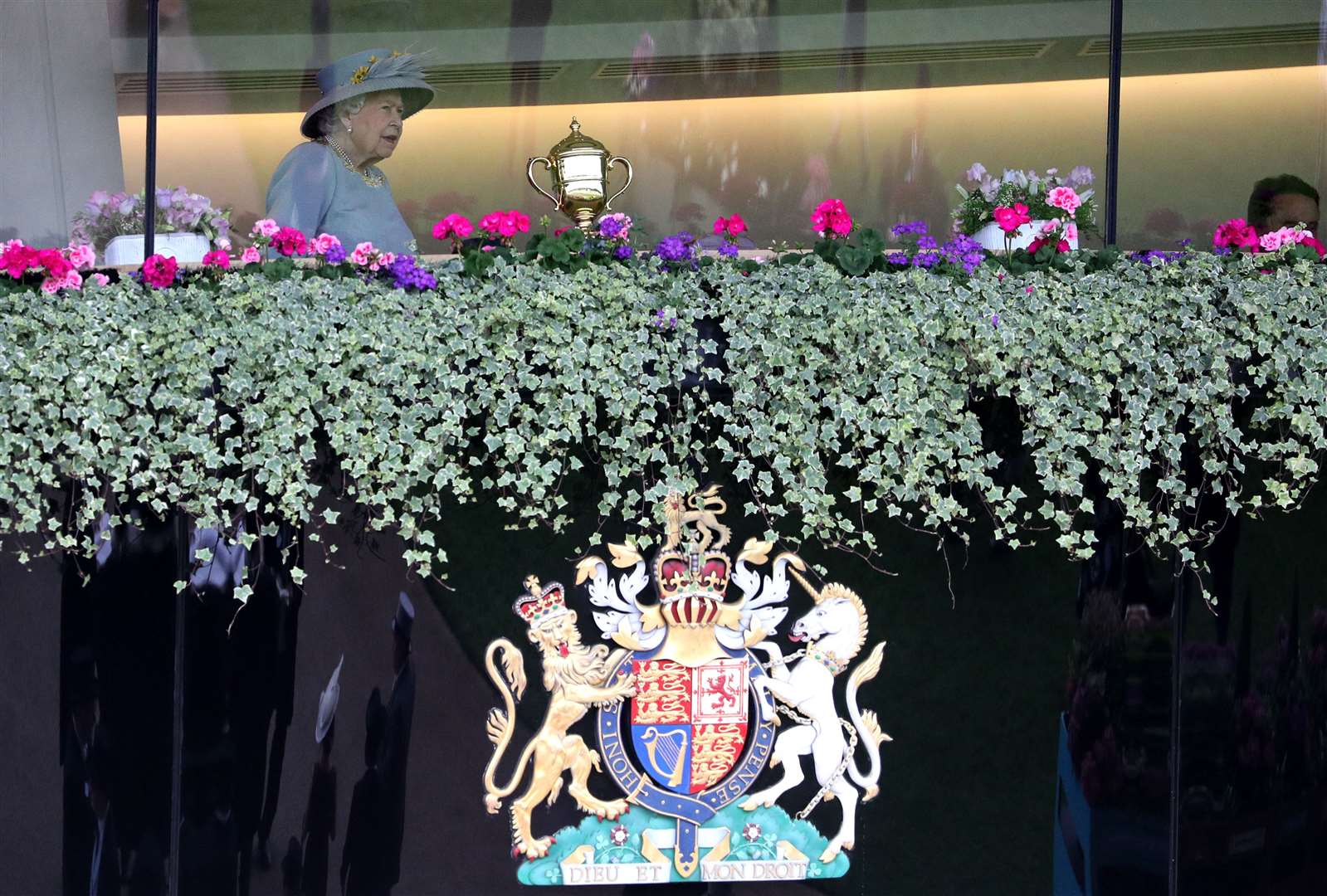 The Queen at Royal Ascot above a royal coat of arms featuring a unicorn (Jonathan Brady/PA)