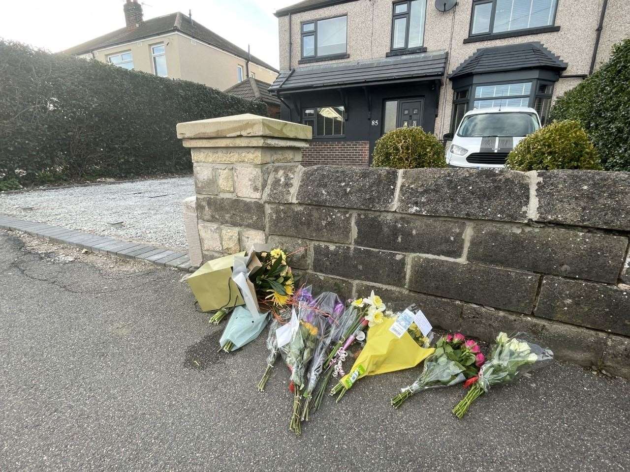 Floral tributes left outside a house on Hemper Lane, Greenhill (Dave Higgens/PA)