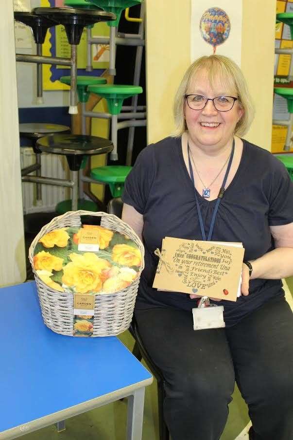 Retiring Port Elphinstone school nursery teacher Una Thompson with her memory book and Begonia Sunray bulbs basket at her farewell last Friday. Picture: Griselda McGregor