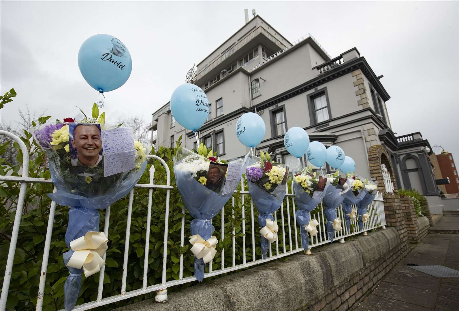 Balloons, flowers, photos and messages at the site of the former Regency Hotel (Brian Lawless/PA)