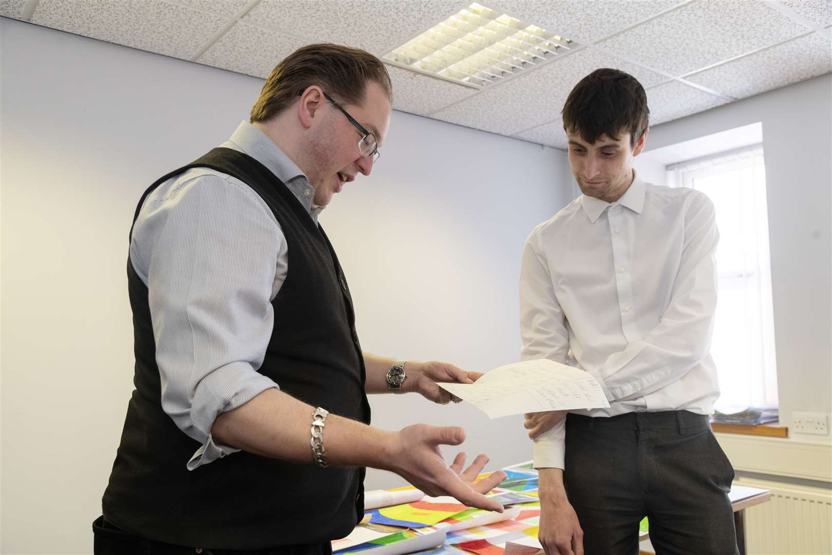 Vexilloligst Philip Tibbetts and Northern Scot chief reporter Jonny Clark casting an eye over entries for the Moray and Banffshire flag competition. Picture: Beth Taylor