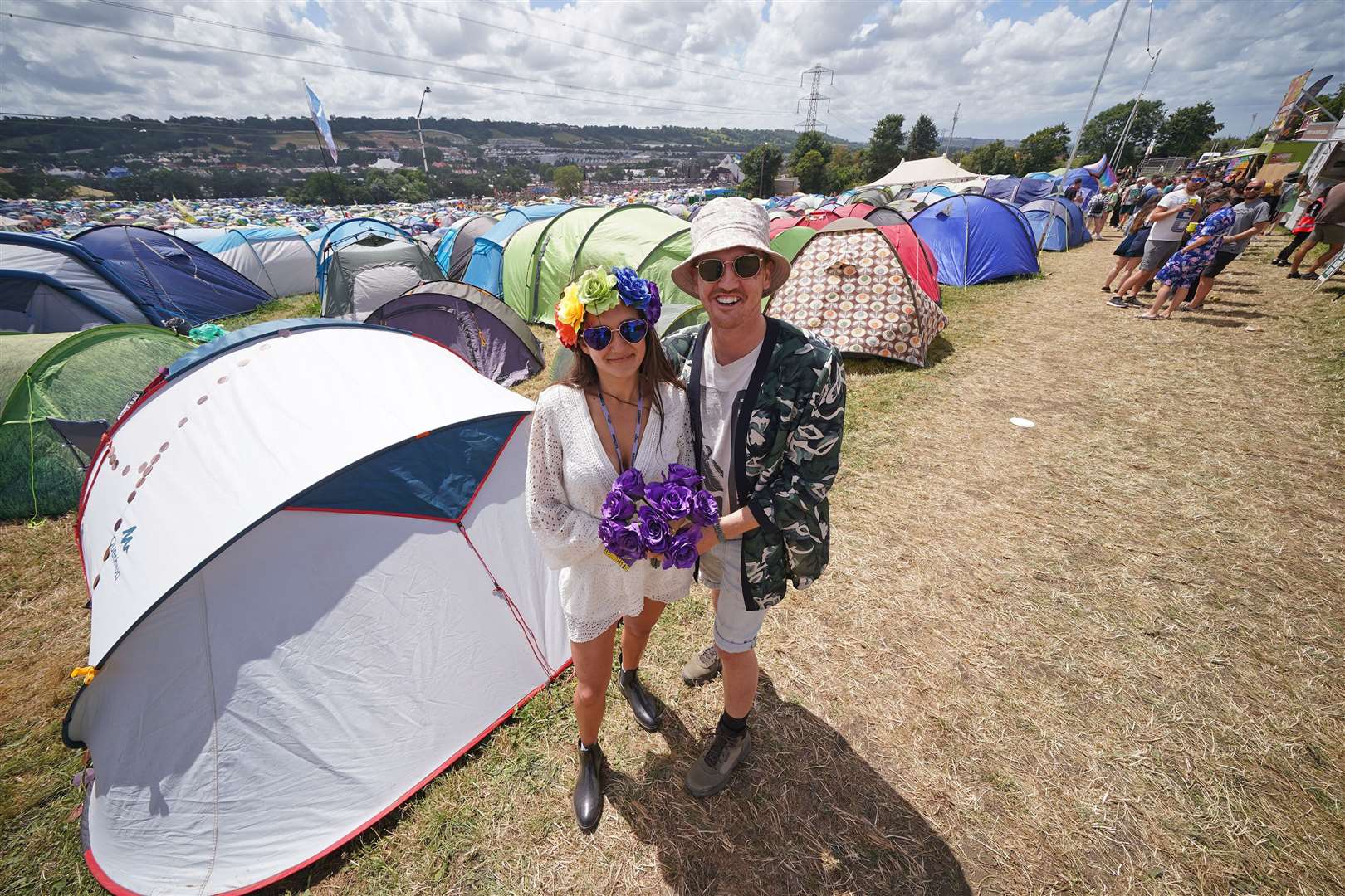 The festivalgoers in front of their temporary home (Yui Mok/PA)