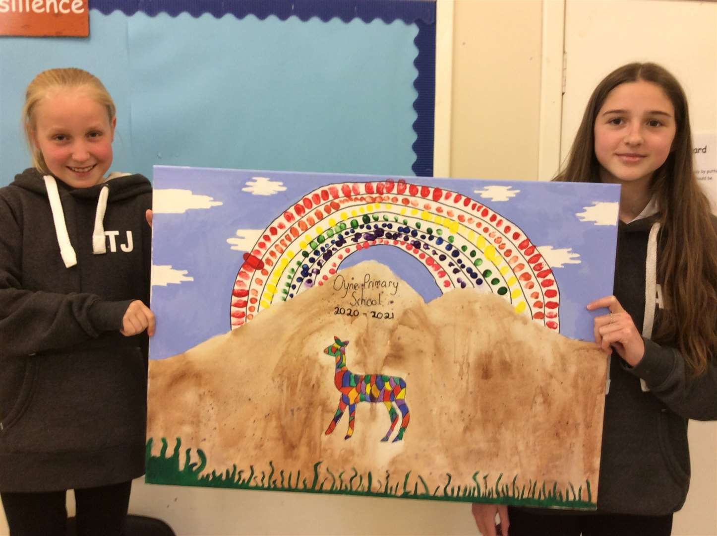Oyne School P7 pupils Tilly James and Amy Erbe with the painted rainbow which is made up of fingerprints of each pupil at the school.