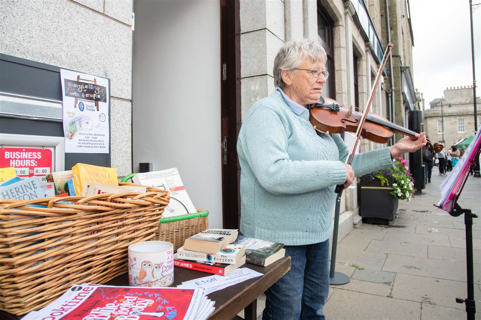 Mary Chapman plays the fiddle outside Orb's Bookshop. Picture: Daniel Forsyth