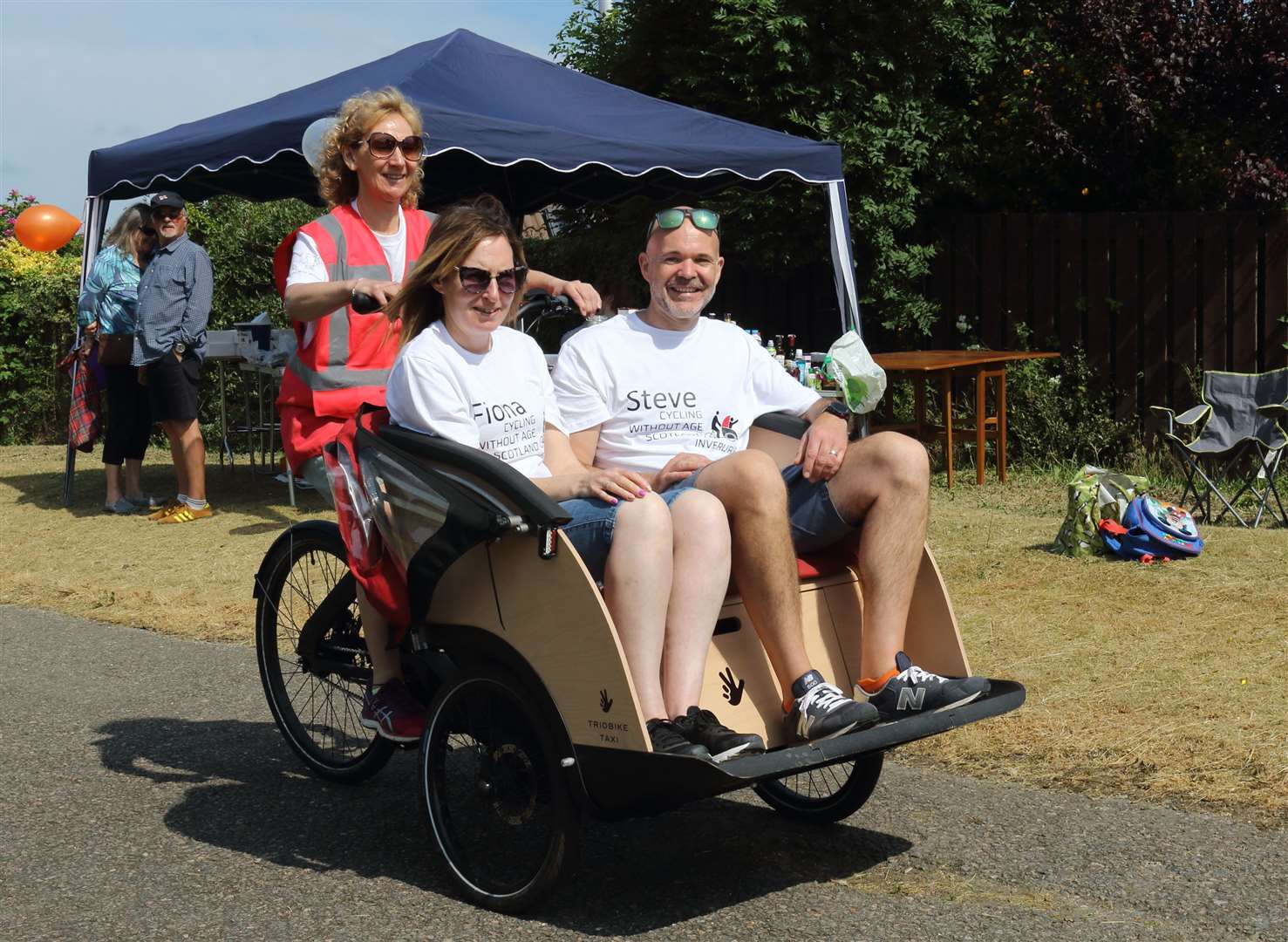 Volunteers try out the trishaw. Picture: David Porter