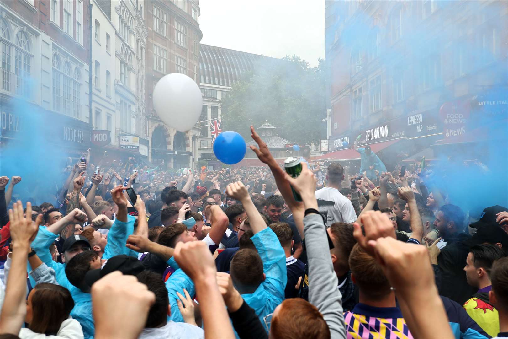 Scotland fans set off blue smoke grenades in Leicester Square ahead of their match against England tonight (Kieran Cleeves/PA)