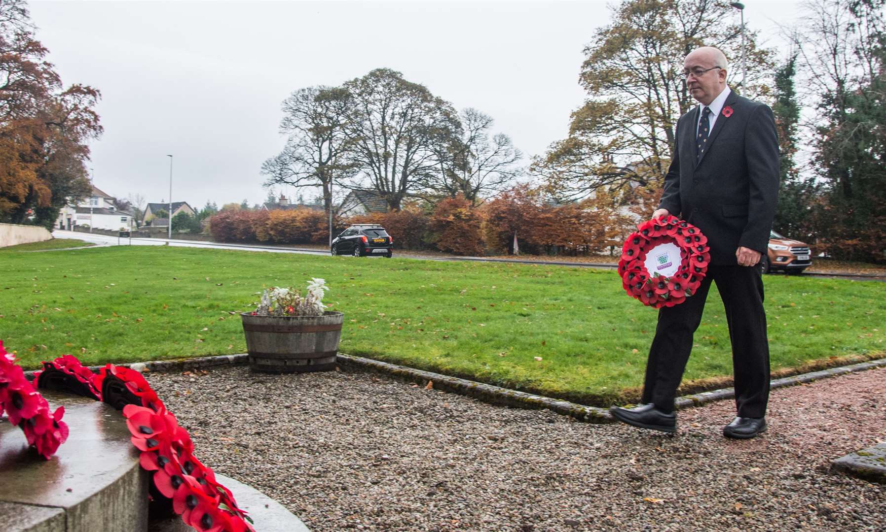 Councillor Marc Macrae lays a wreath on behalf of Moray Council at Fochabers war memorial on Remembrance Day 2020. Picture: Becky Saunderson.