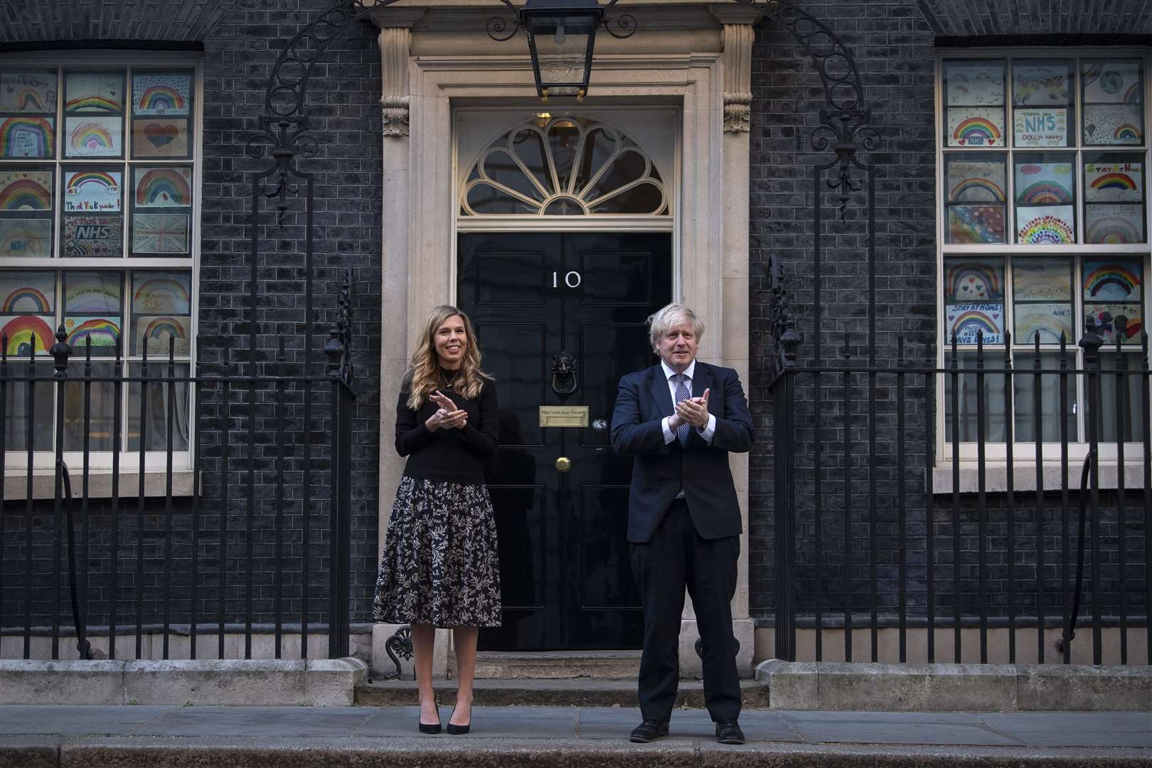 Ms Symonds and Mr Johnson join in the Thursday night clap for carers in May outside No 10 (Victoria Jones/PA)