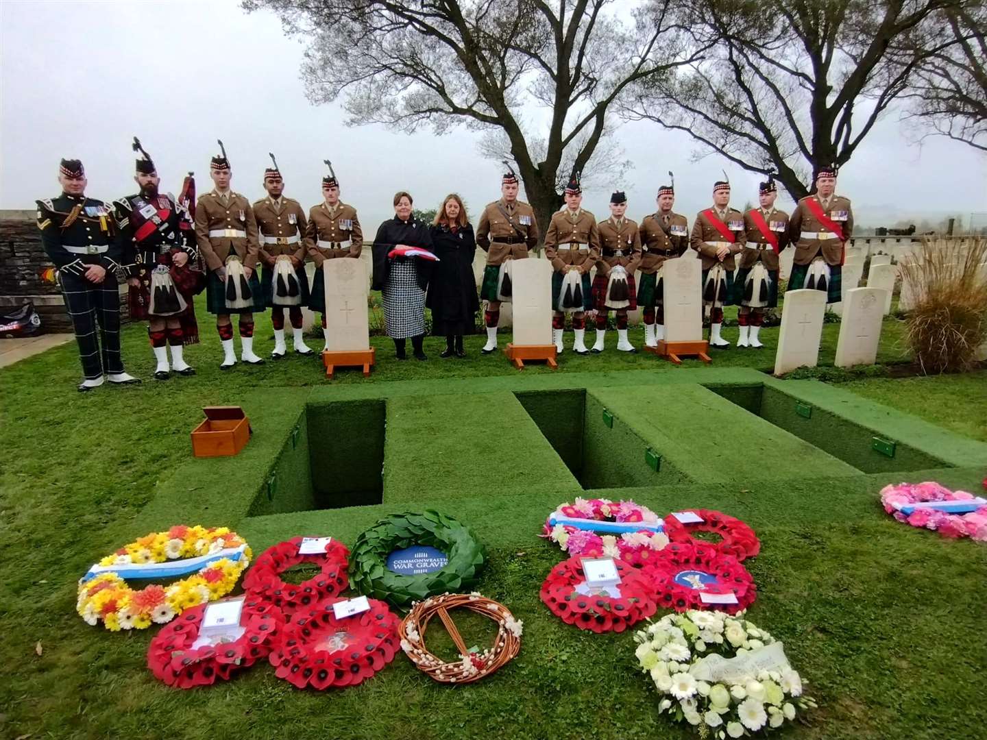 A military party and Lance Serjeant Robert Brand’s relatives beside his grave (MoD/PA)