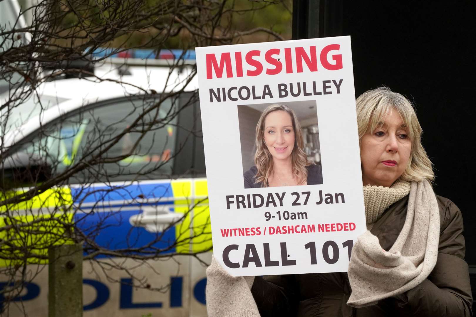 Friends of Nicola Bulley hold missing person appeal posters (Owen Humphreys/PA)