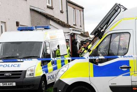 Police vehicles surround the house in Wallace Avenue. Photos by Lyn MacDonald, Banffshire Advertiser.
