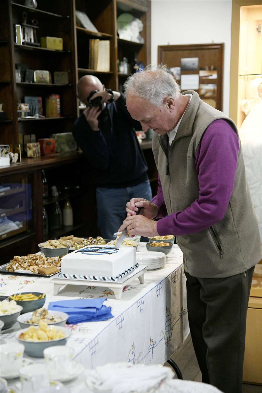 The heritage group's last surviving original member John Rennie cuts the commemorative cake. Picture: Beth Taylor