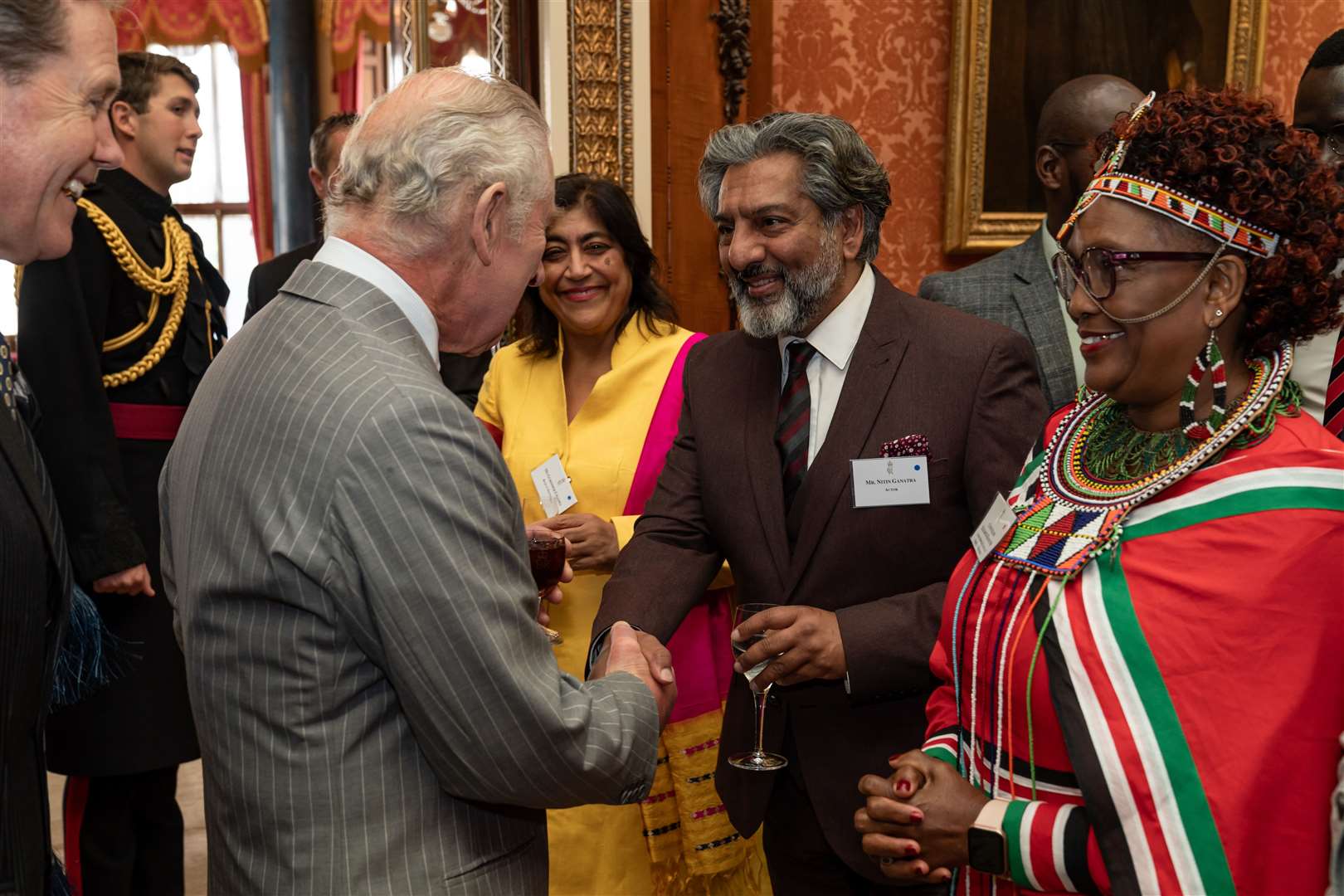 The King shakes hands with actor Nitin Ganatra (Aaron Chown/PA)