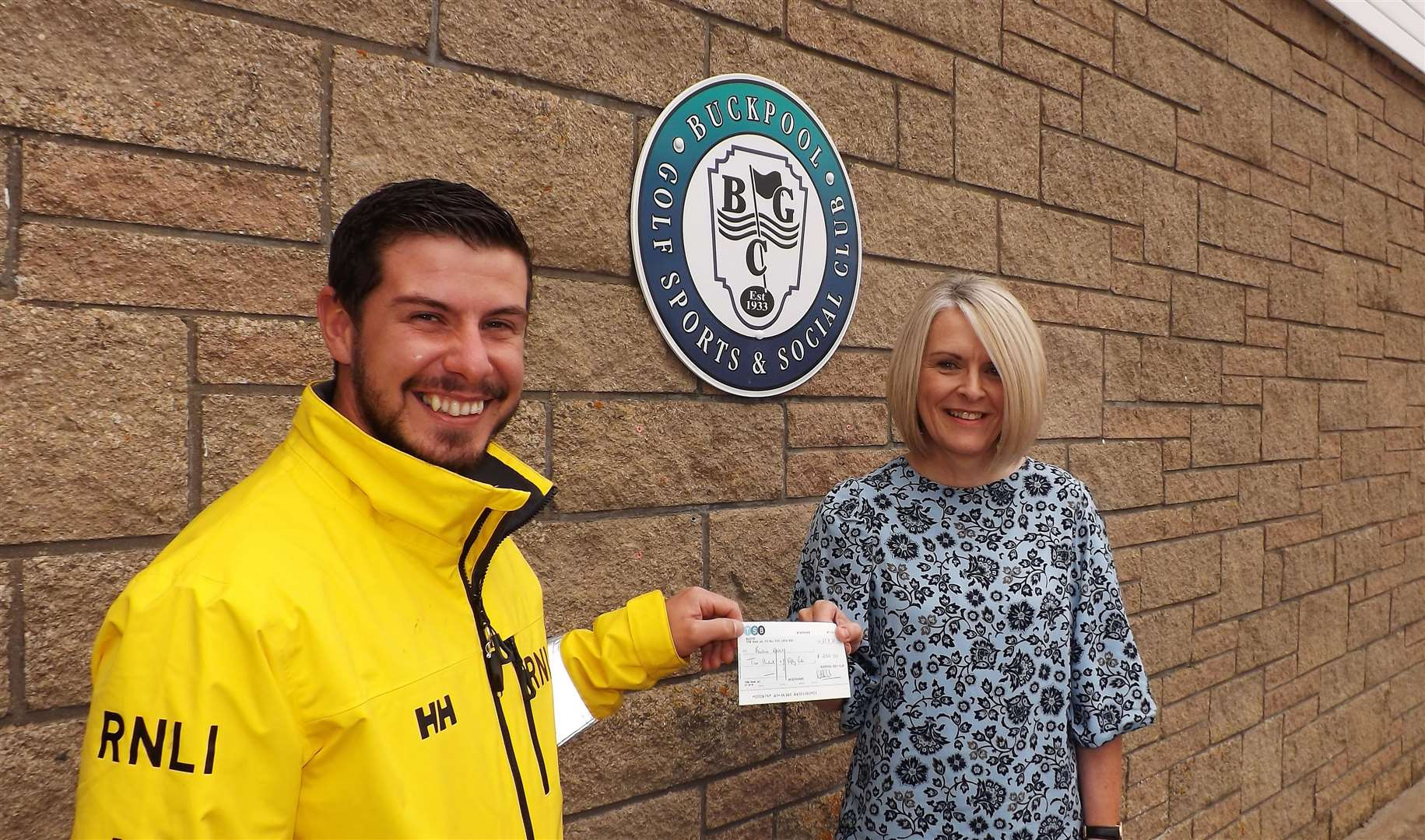 Gav accepts the £250 donation from Amanda.