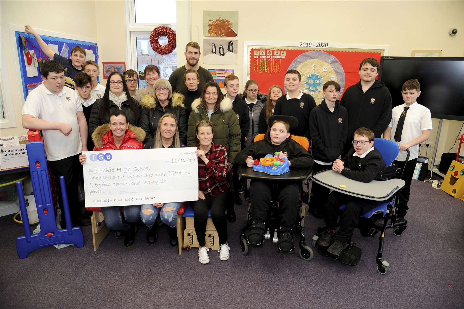 Suzanne Clark (seated, second left) presents a cheque for £9254.76 to the special education department at Buckie High. Picture: Eric Cormack