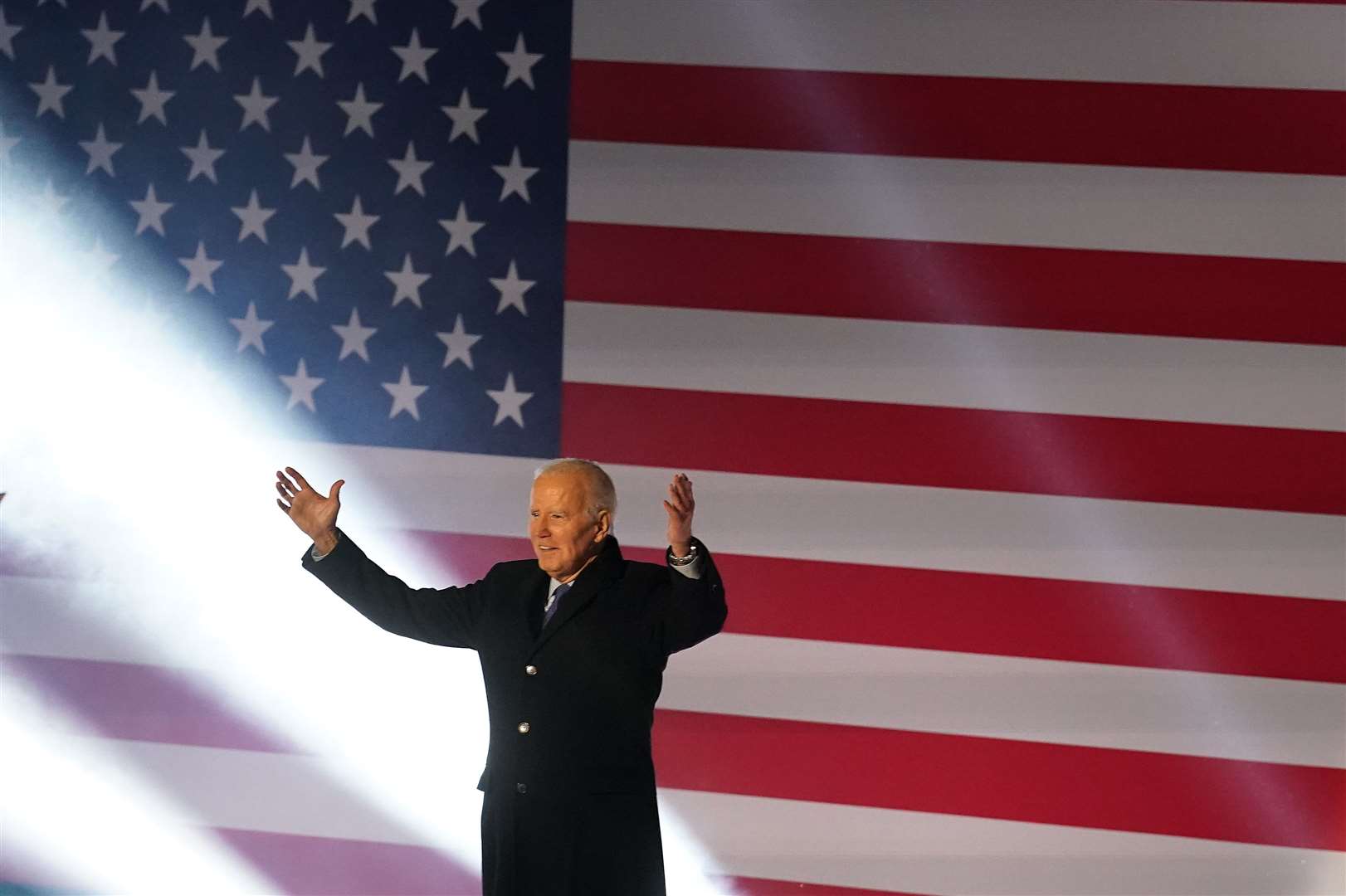 US president Joe Biden arrives on stage on Friday (Brian Lawless/PA)