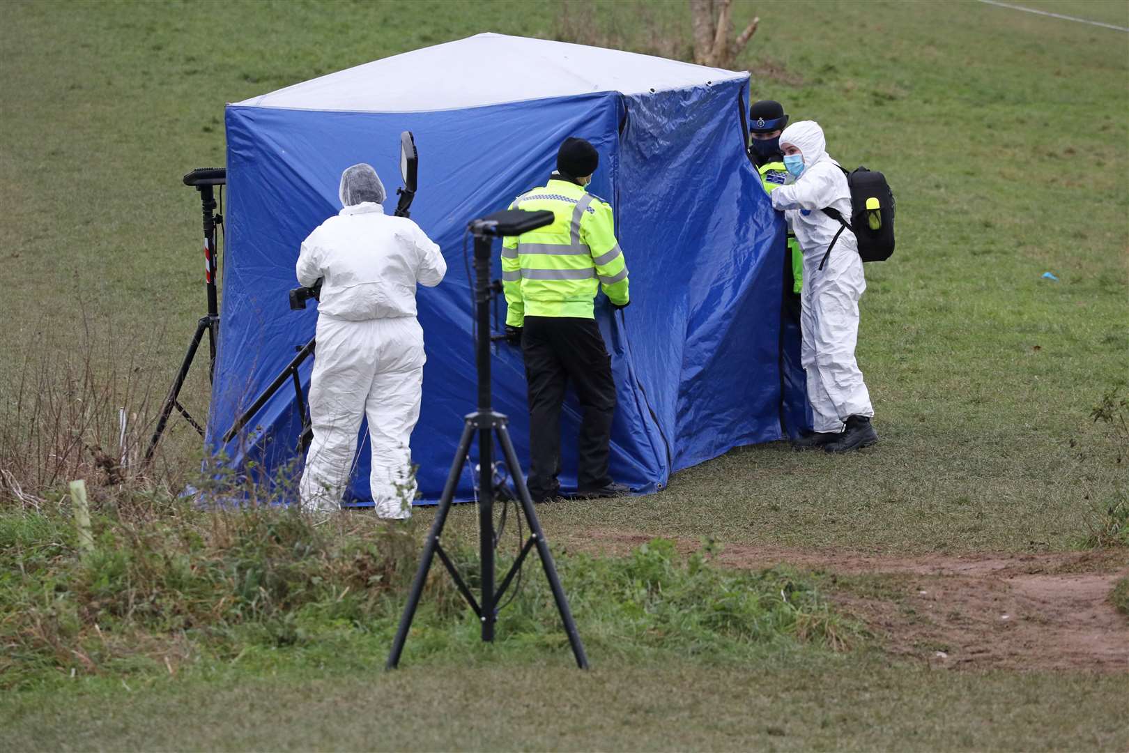 Investigators at a forensic tent in Bugs Bottom field, Emmer Green (PA)