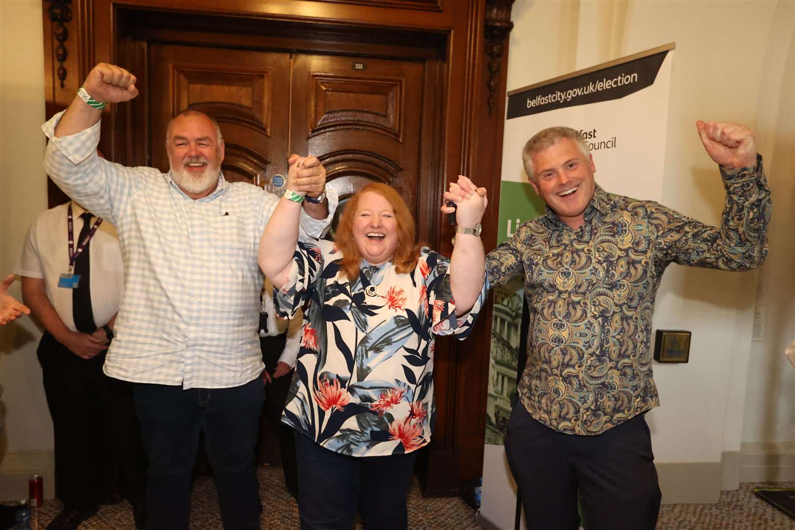 Alliance Party leader Naomi Long (centre) with Eric Hanvey (left) and her husband Michael Long (right) at Belfast City Hall (Liam McBurney/PA)