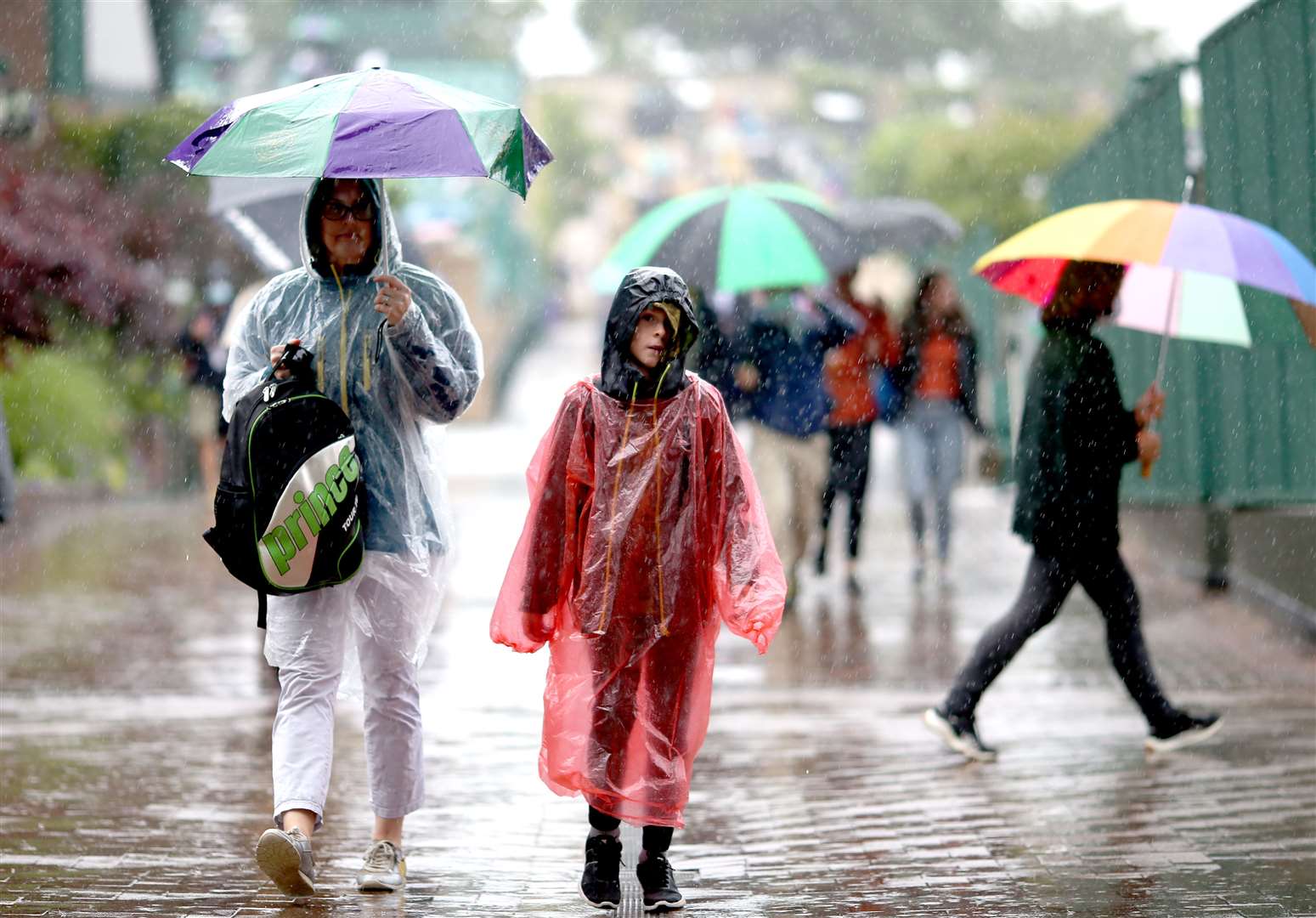 Spectators shelter from the heavy rain on day two of Wimbledon (Steven Paston/PA Images)