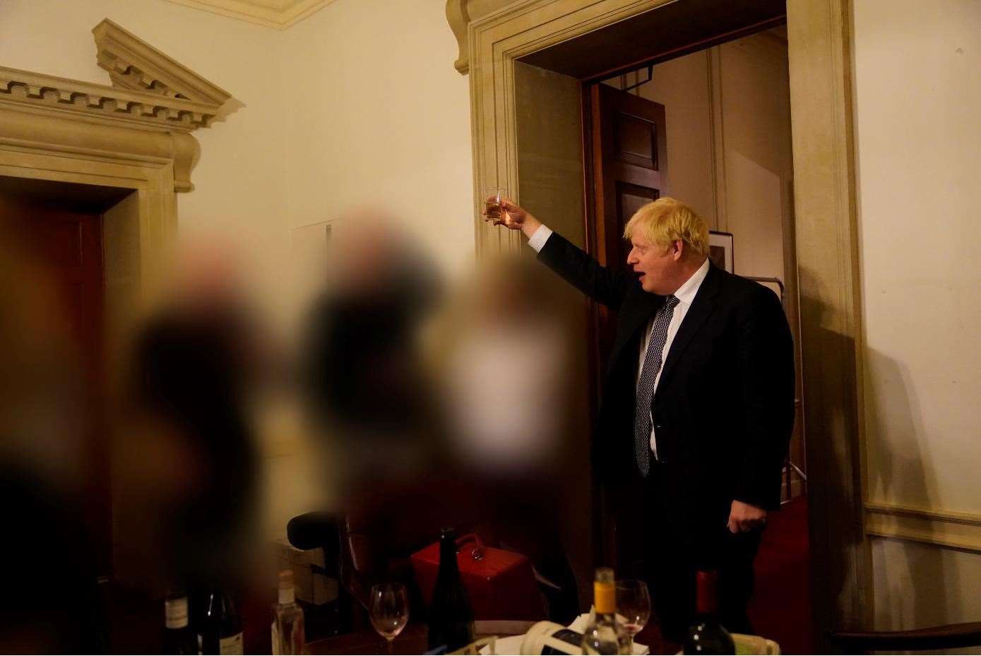 Pictures of Boris Johnson toasting staff at a lockdown leaving do featured in the Sue Gray report (Sue Gray Report/Cabinet Office)