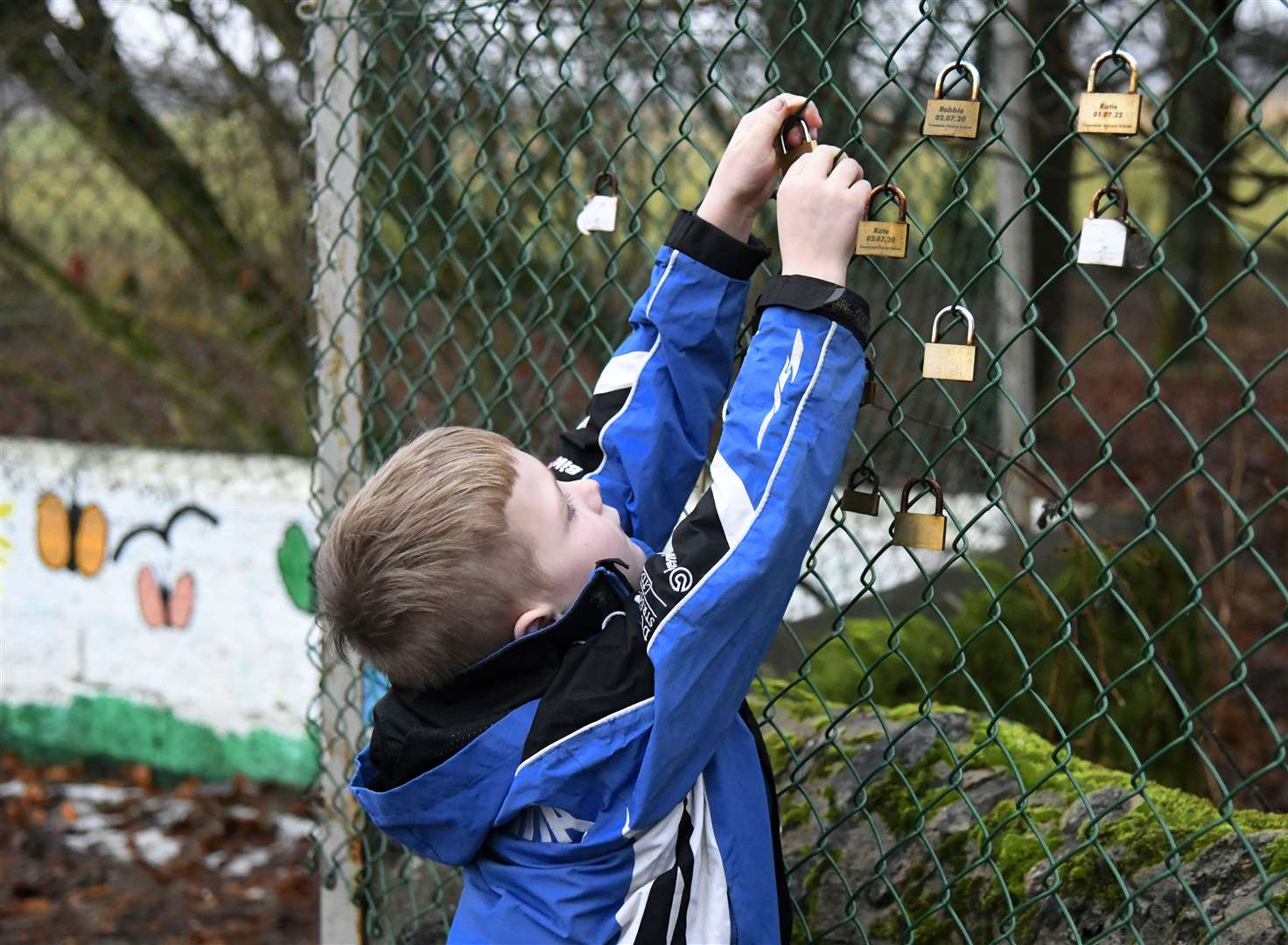 Charlie locking his padlock onto the fence. ..Picture: Beth Taylor.
