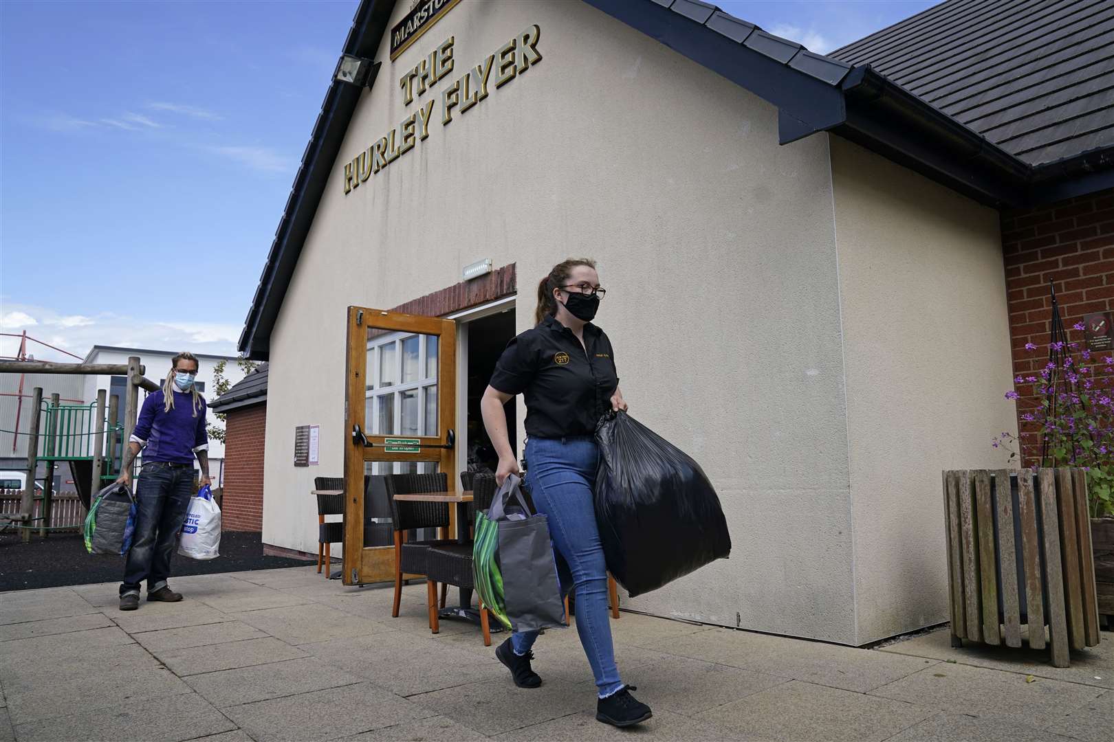 Staff carry bags of donations at the Hurley Flyer pub in Morecambe (Danny Lawson/PA)