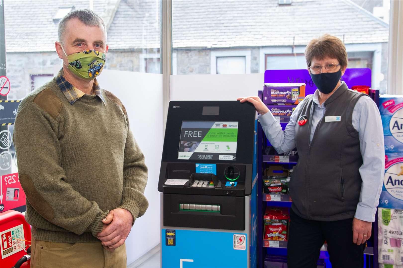 Good to see you...Cullen and Deskford Community Council chairman Stewart Black and Cullen Co-op manager Karen Flett admire the town's new ATM. Picture: Daniel Forsyth