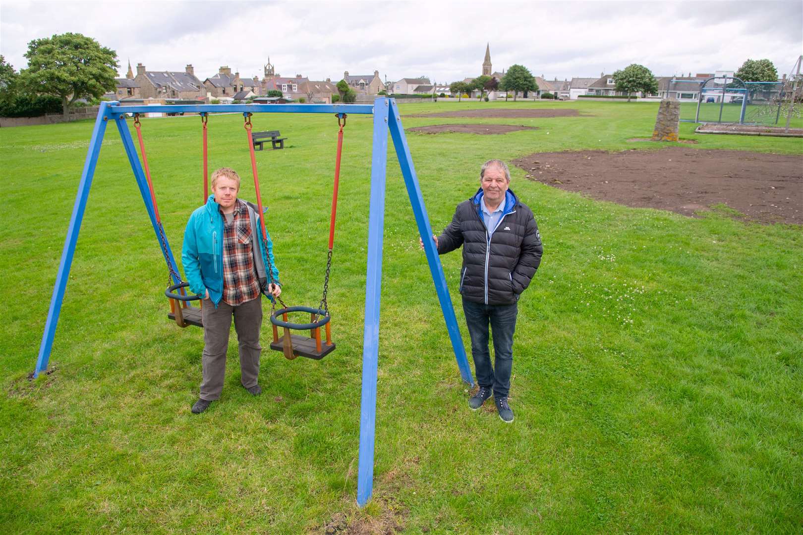 Buckie Councillors Tim Eagle (left) and Gordon Cowie have hailed the start of work to replace play equipment at the Ian Johnston Park. Picture: Daniel Forsyth