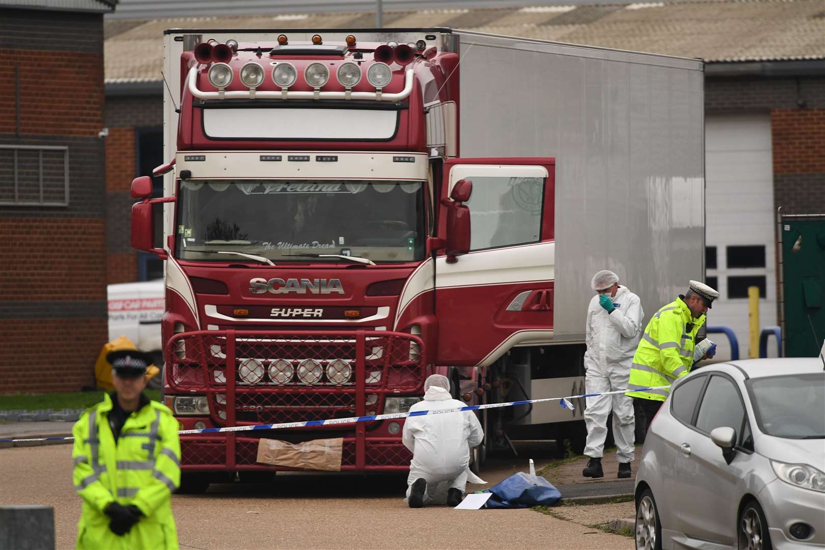 Police and forensic officers at the lorry where 39 bodies of Vietnamese migrants were found (Stefan Rousseau/PA)