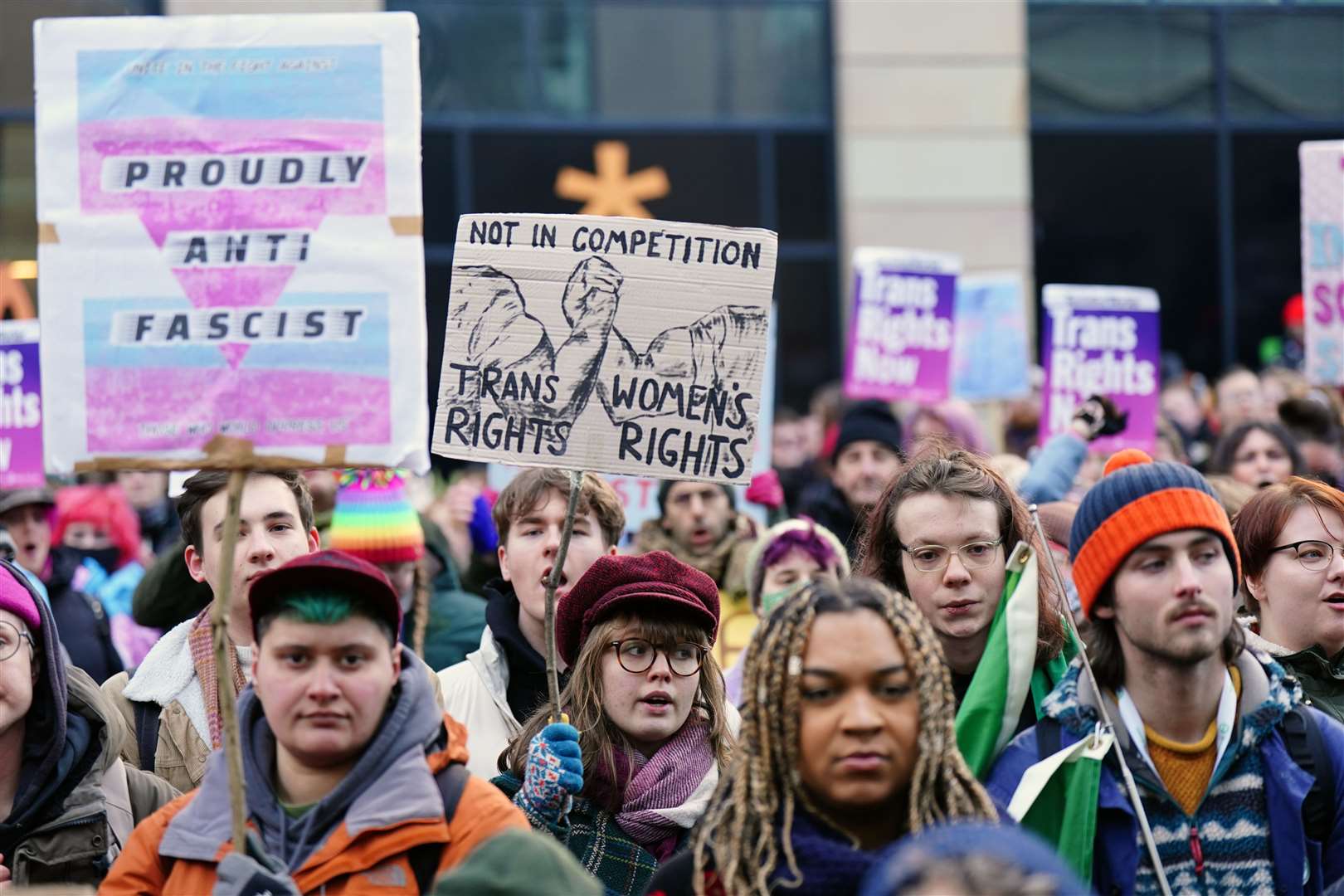 People take part in a demonstration for trans rights outside the UK Government Office at Queen Elizabeth House in Edinburgh (Jane Barlow/PA)