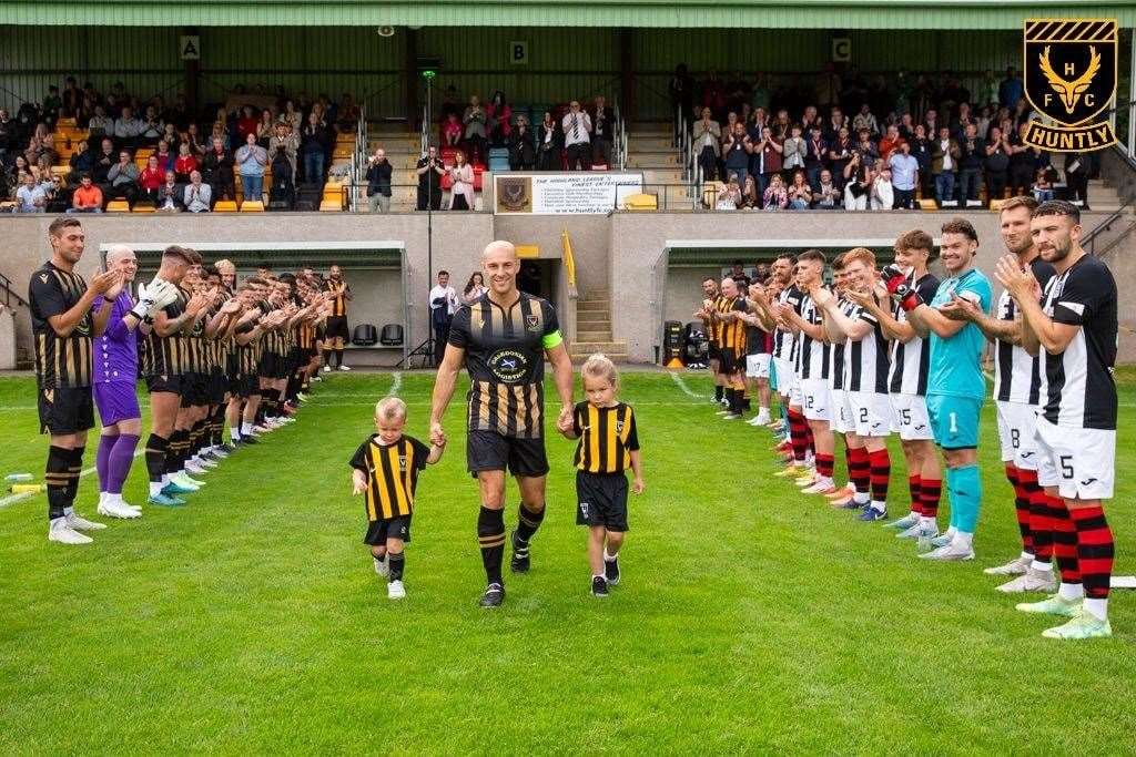 The Huntly and Elgin players formed a guard of honour for Alex Thoirs and his family. Photo: George Mackie