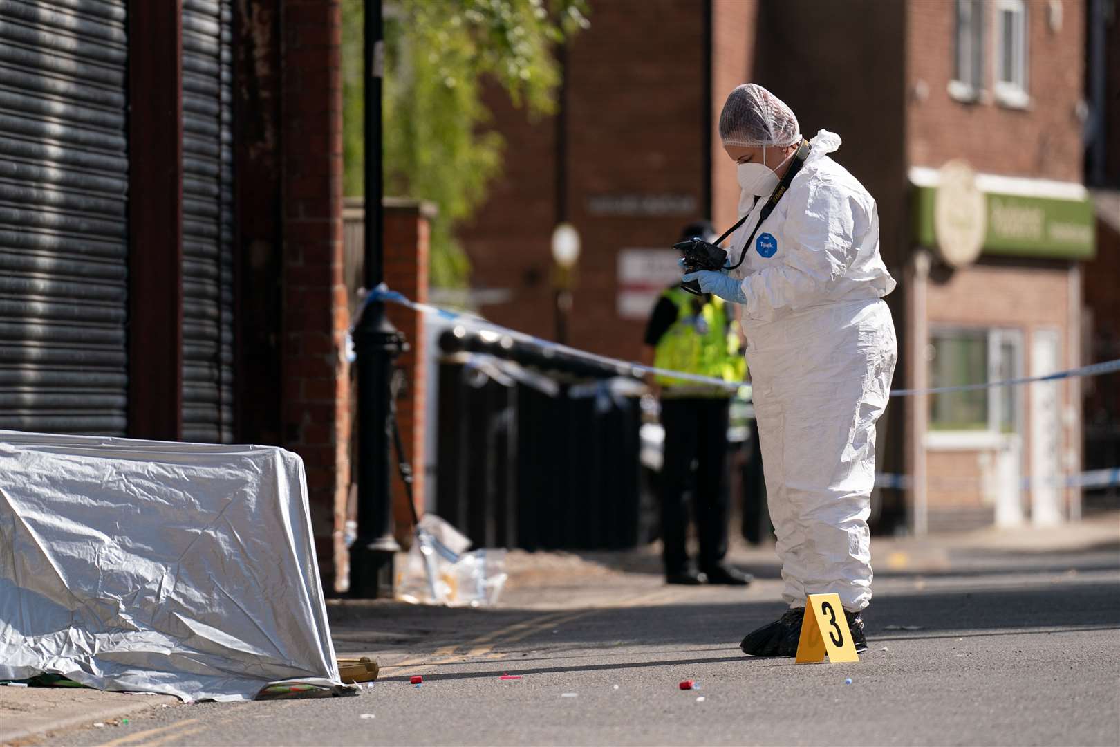 A forensic officer near the scene in Boston (Joe Giddens/PA)