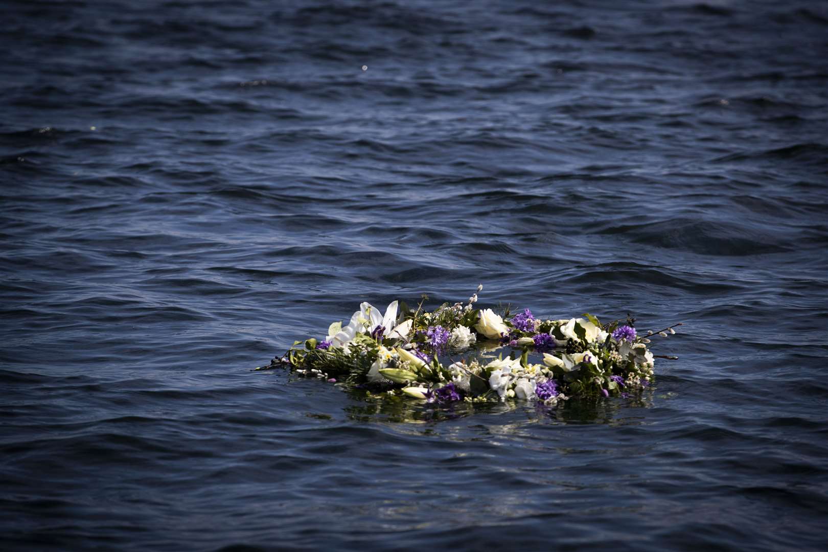 Young sailors at the Duke of Edinburgh’s former school, Gordonstoun in Moray, laid a wreath in the harbour where he learned to sail (Jane Barlow/PA)