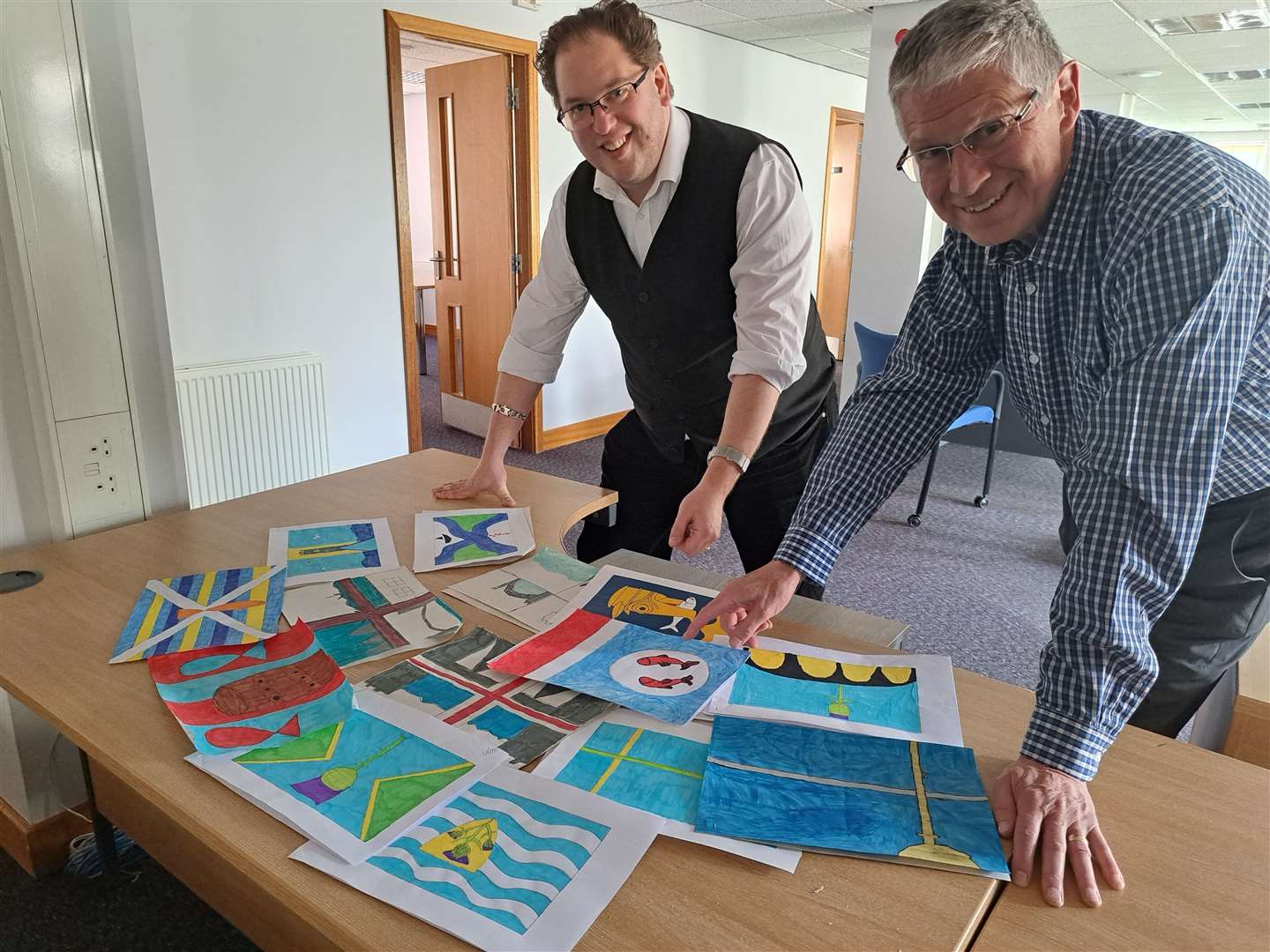 Lord lieutenant of Banffshire Andrew Simpson (right) and vexillologist Philip Tibbetts look through competition entries.