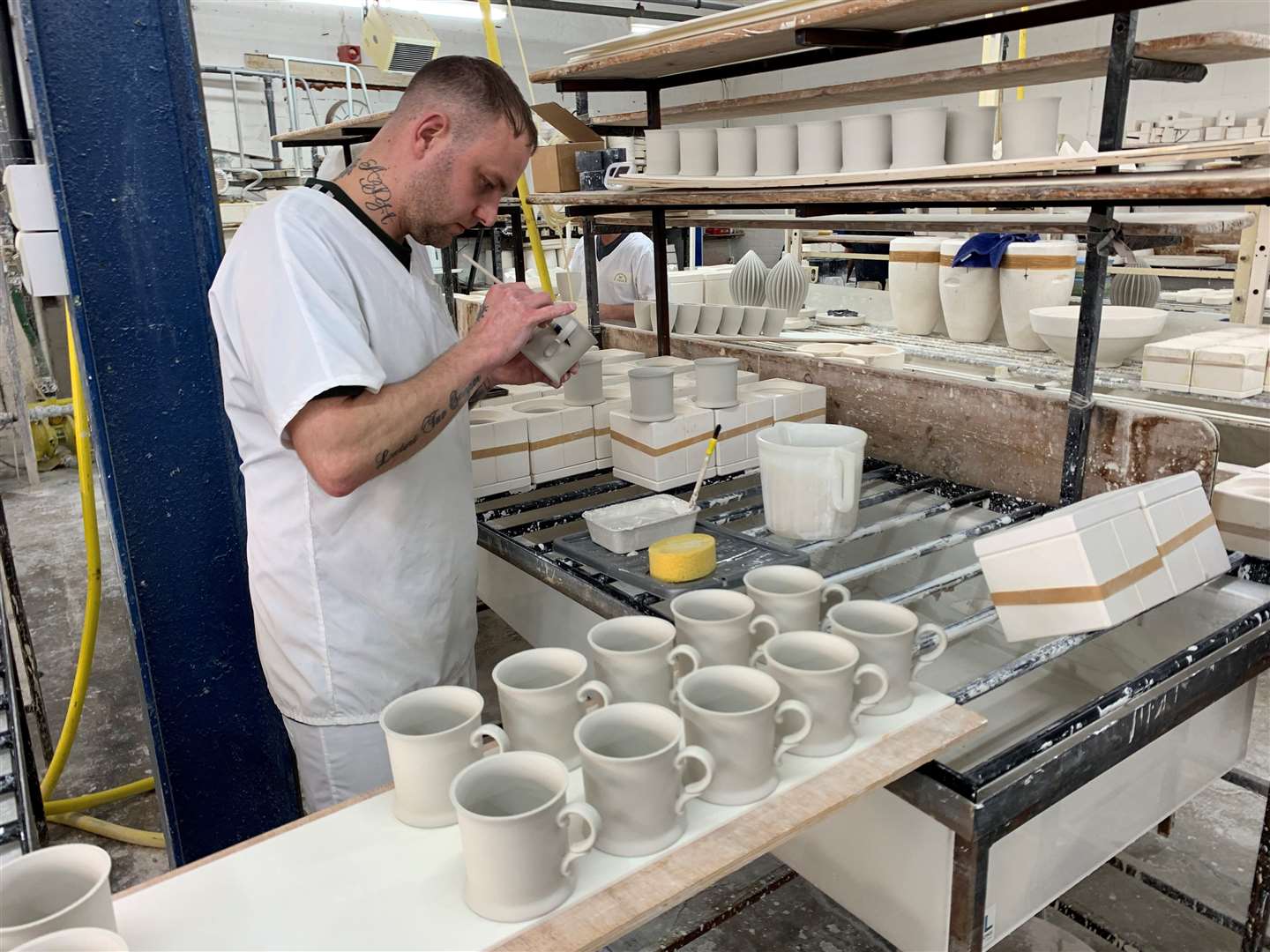 Handles being fitted to unfired clay pieces (Richard Vernalls/PA)