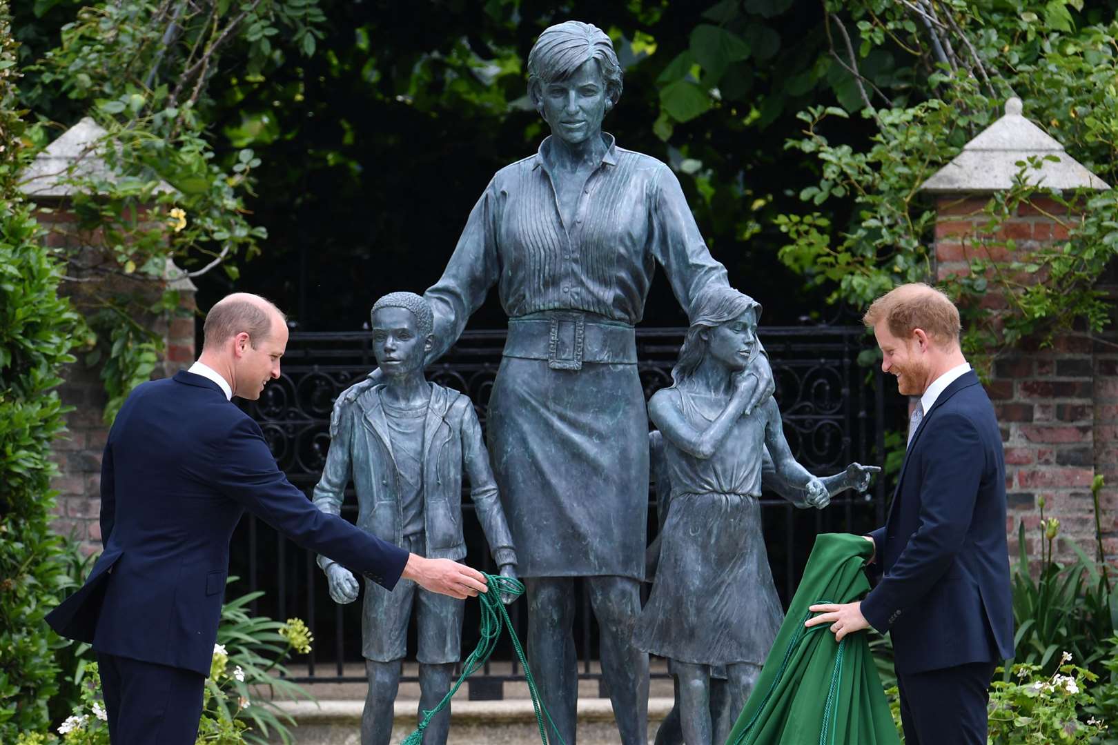 The Duke of Cambridge and Duke of Sussex unveiling a statue they commissioned of their mother Diana, Princess of Wales (Dominic Lipinski/PA)