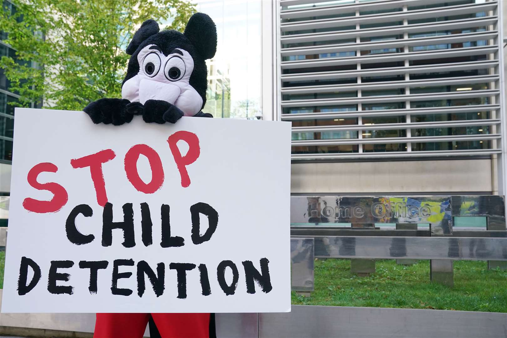 Comedian Dom Joly, dressed as Mickey Mouse, leads a Save the Children protest against the Illegal Migration Bill, outside the Home Office in central London (Lucy North/PA)