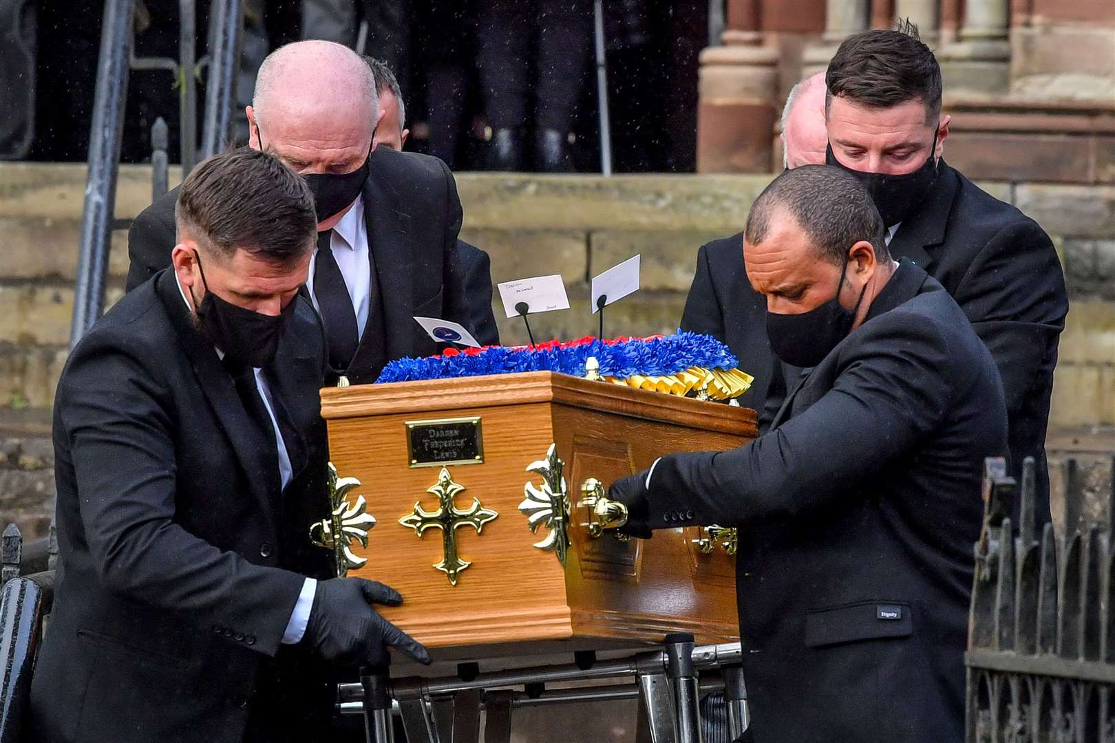 Funeral directors carry the coffin of Darren Lewis from church (Ben Birchall/PA)