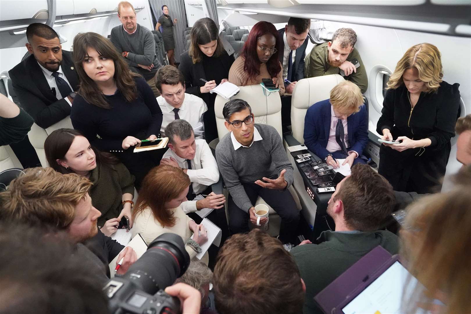 Prime Minister Rishi Sunak holds a ‘huddle’ press conference with political journalists on the flight to Dubai (Stefan Rousseau/PA)