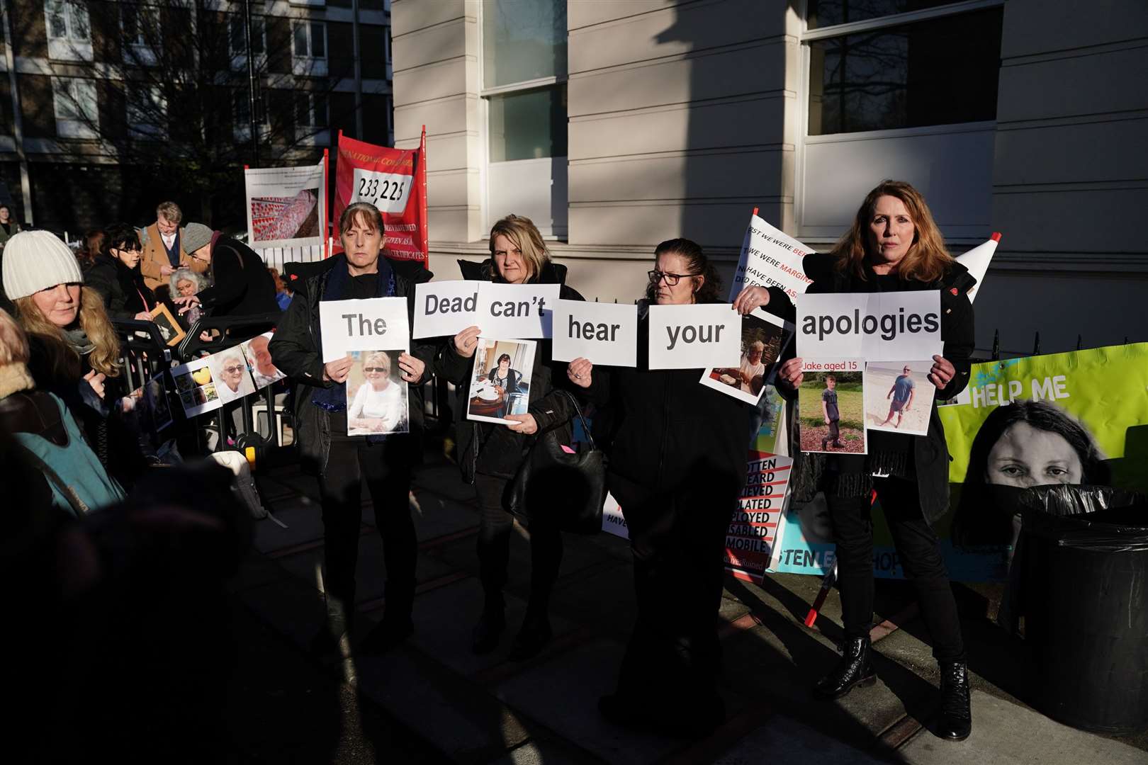 The women held photos of their loved ones and signs that read ‘The dead can’t hear your apologies'(Jordan Pettitt/PA)