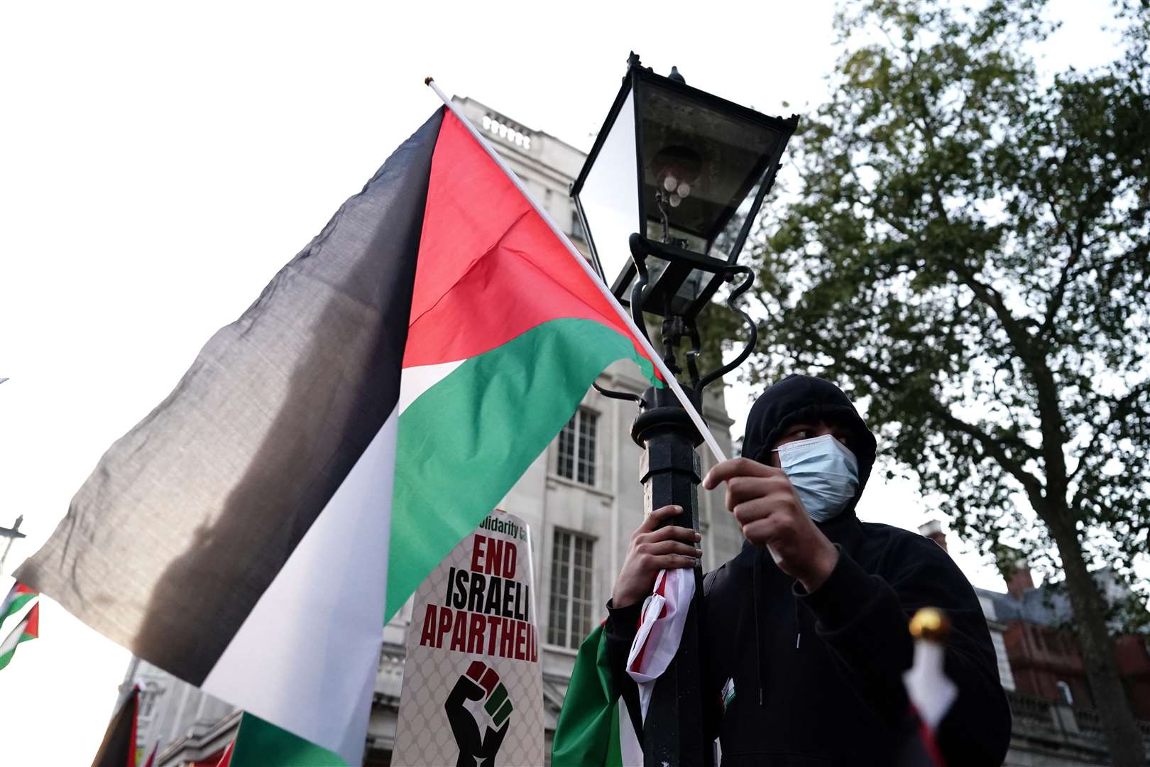 People take part in a Palestine Solidarity Campaign demonstration near the Israeli Embassy in London (Jordan Pettitt/PA)